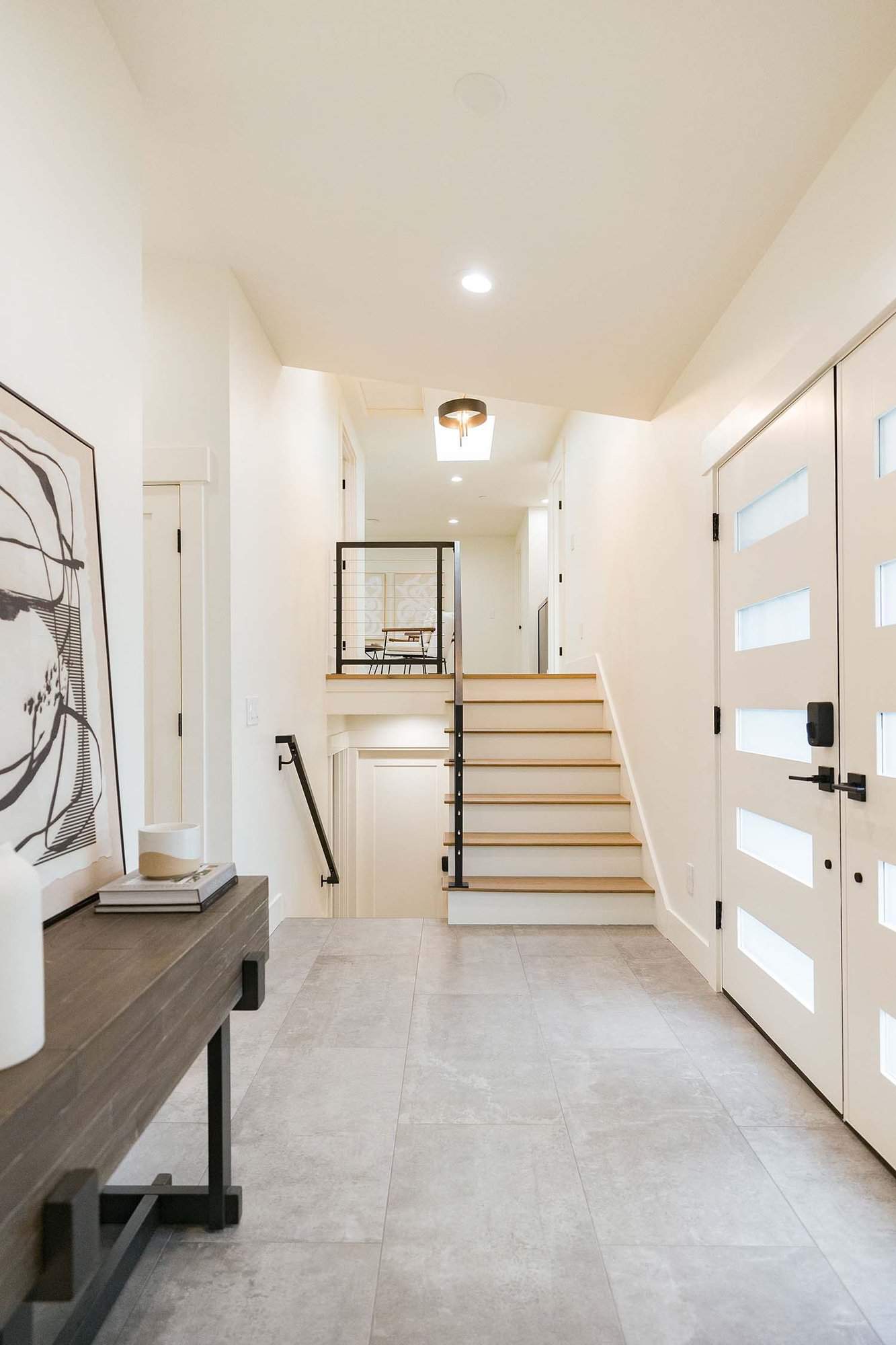 modern tri-level home entry with a console table and staircase