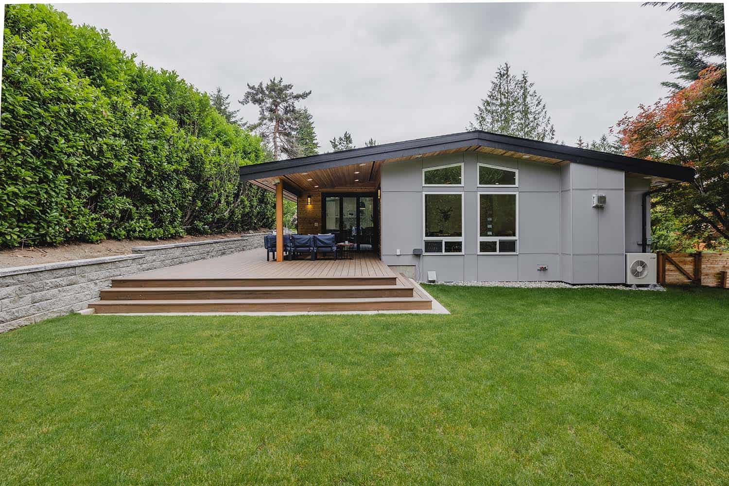 tri-level home backyard with a deck