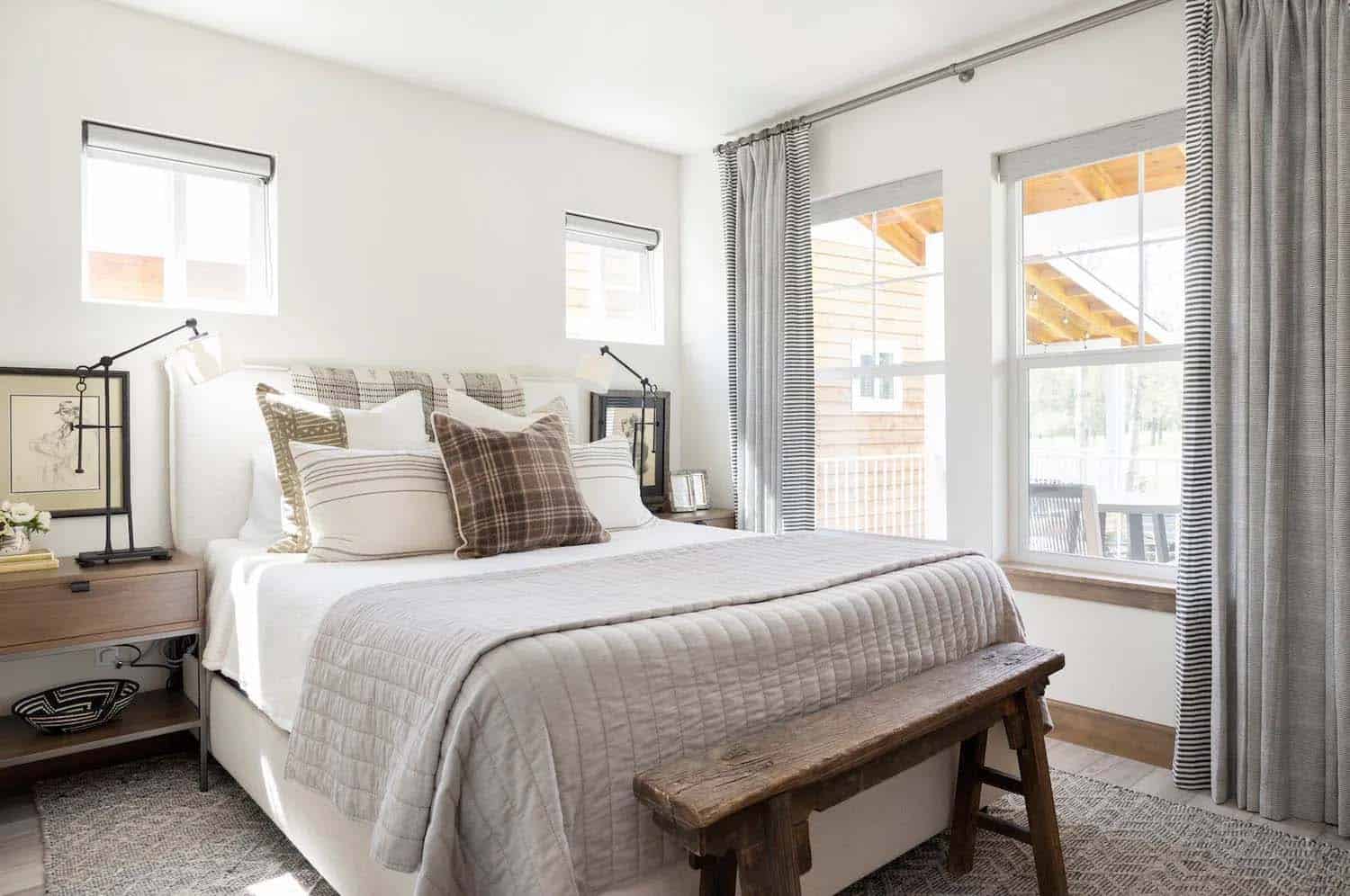 scandinavian style bedroom with a rustic wood bench