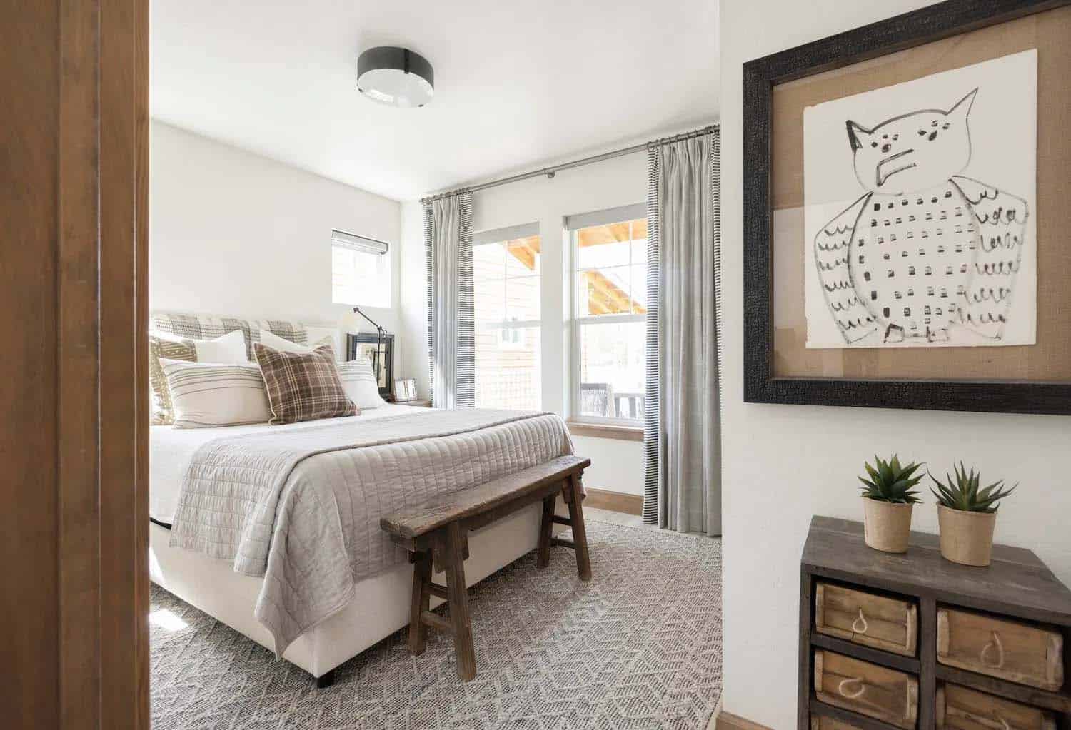 scandinavian style bedroom with a rustic wood bench