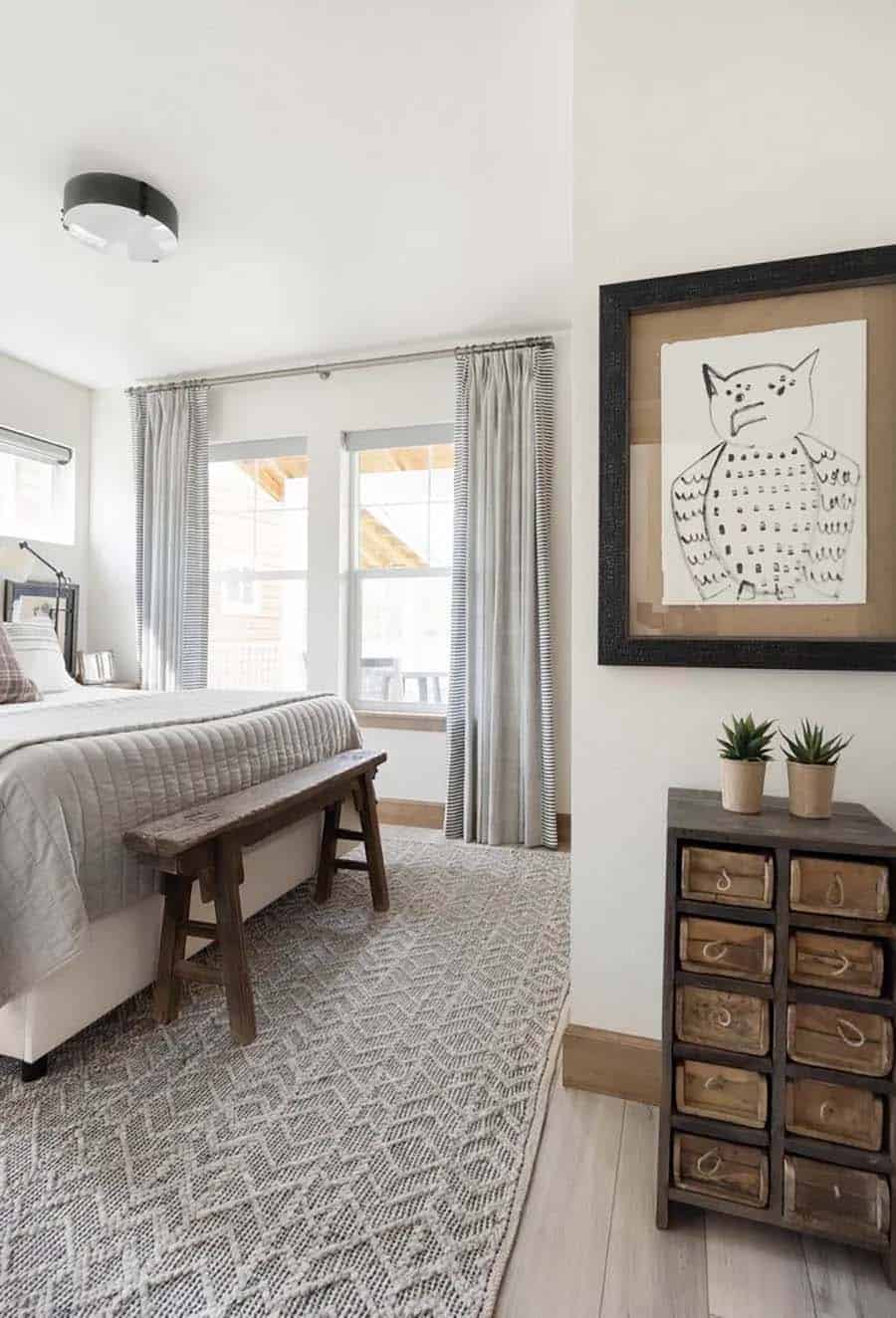 scandinavian style bedroom with a rustic wood bench