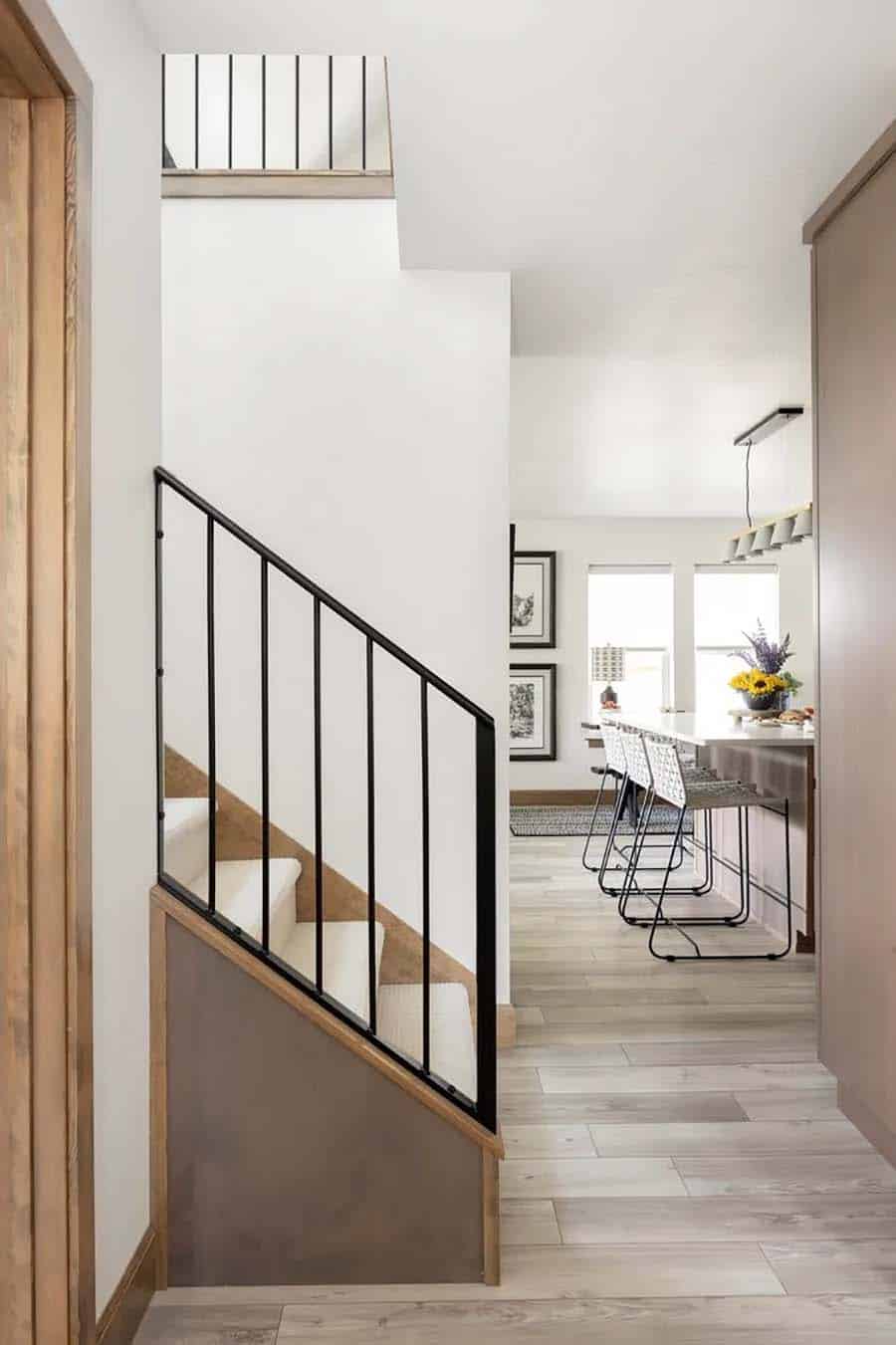 scandinavian style staircase with a metal railing