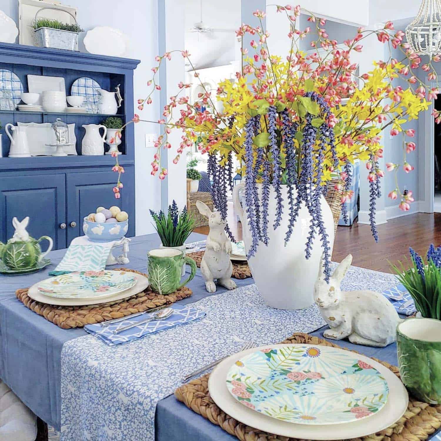 spring dining table with a a large floral centerpiece 