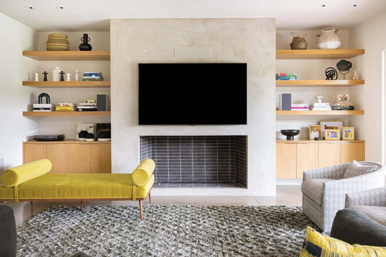 modern living room with fireplace and a chaise lounge