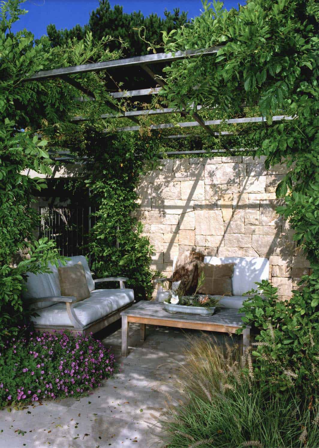 outdoor living room with a vine covered pergola