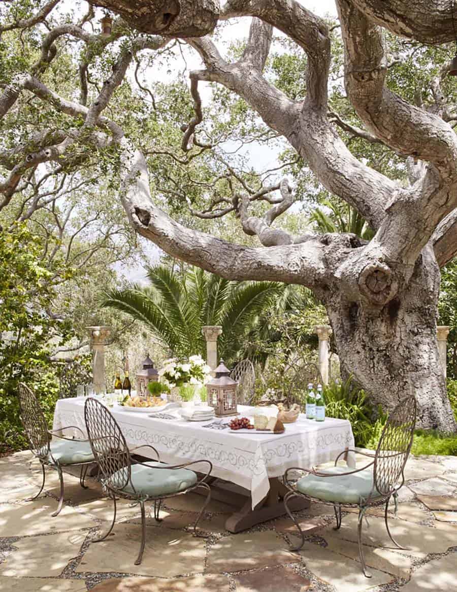 alfresco dining room with a massive oak tree