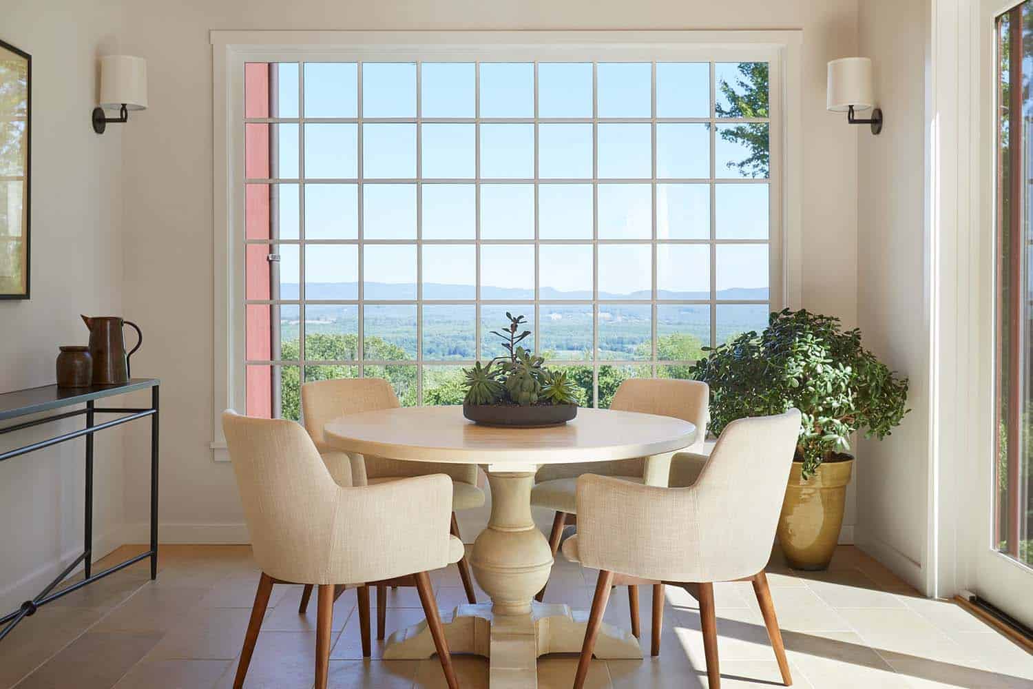 contemporary sunroom with a dining table