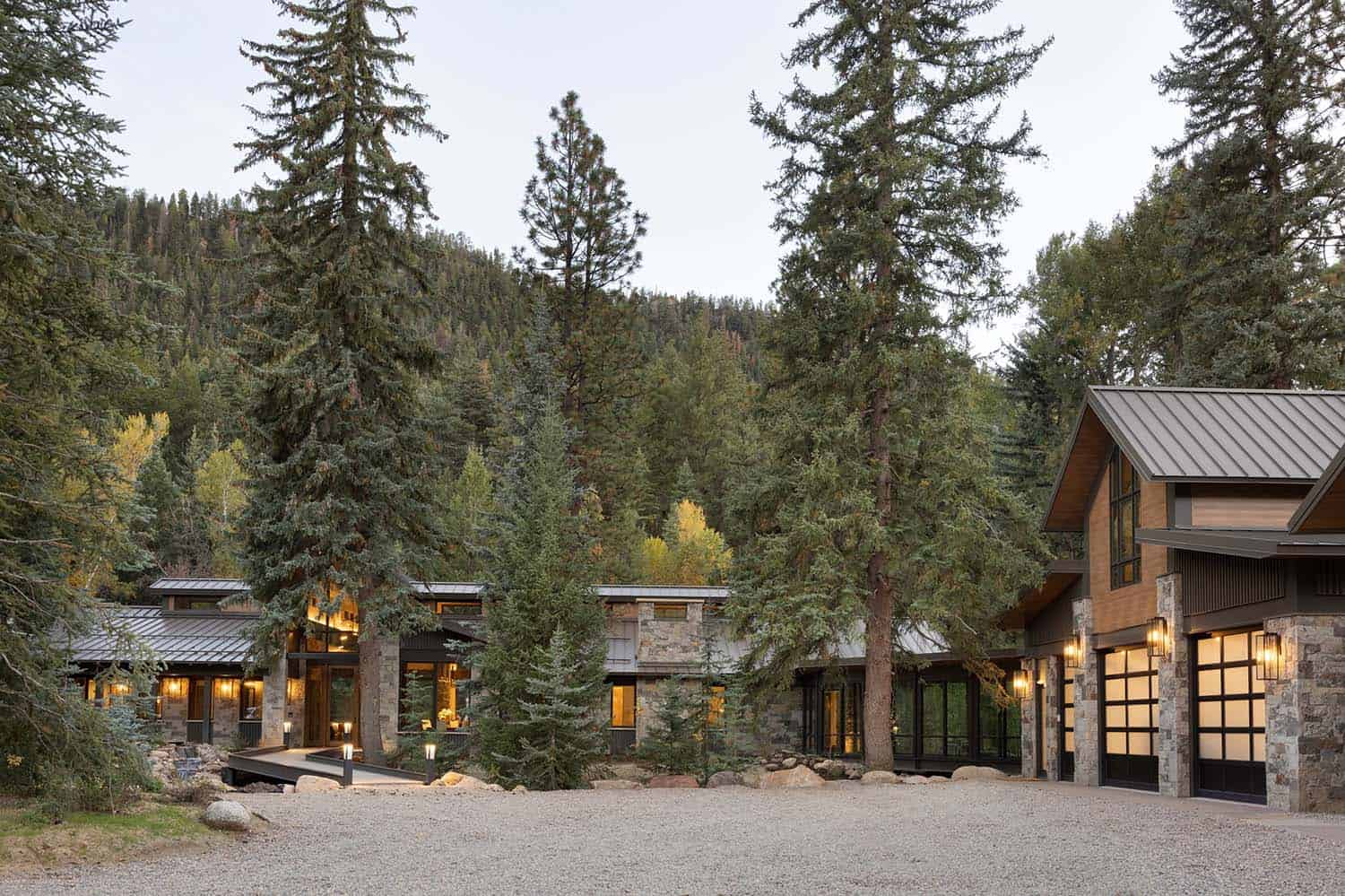 modern rustic mountain home exterior at dusk