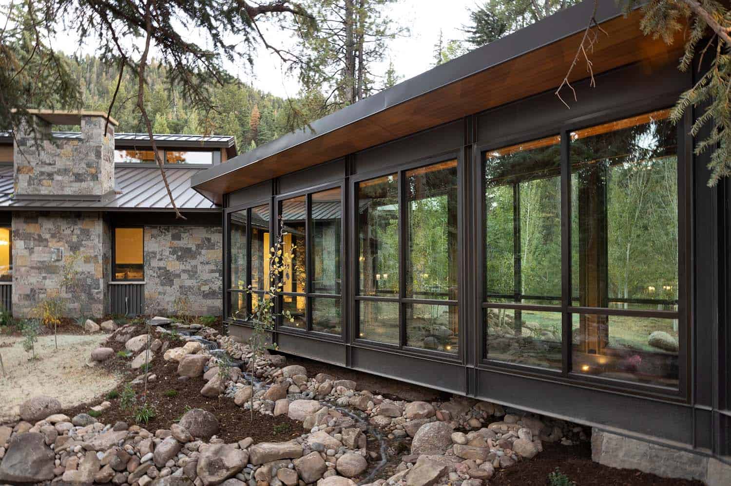 modern rustic mountain home exterior with a bridge