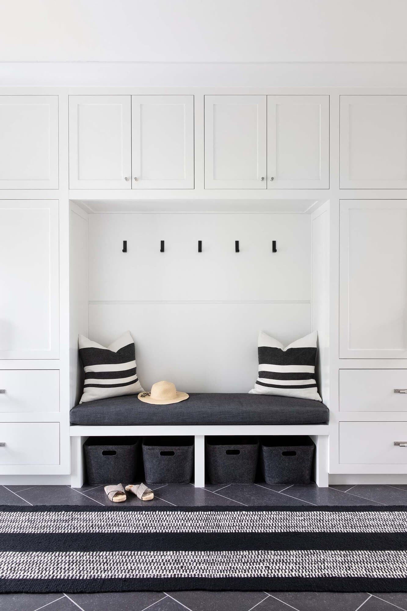 transitional style mudroom with a built-in bench and storage cabinets