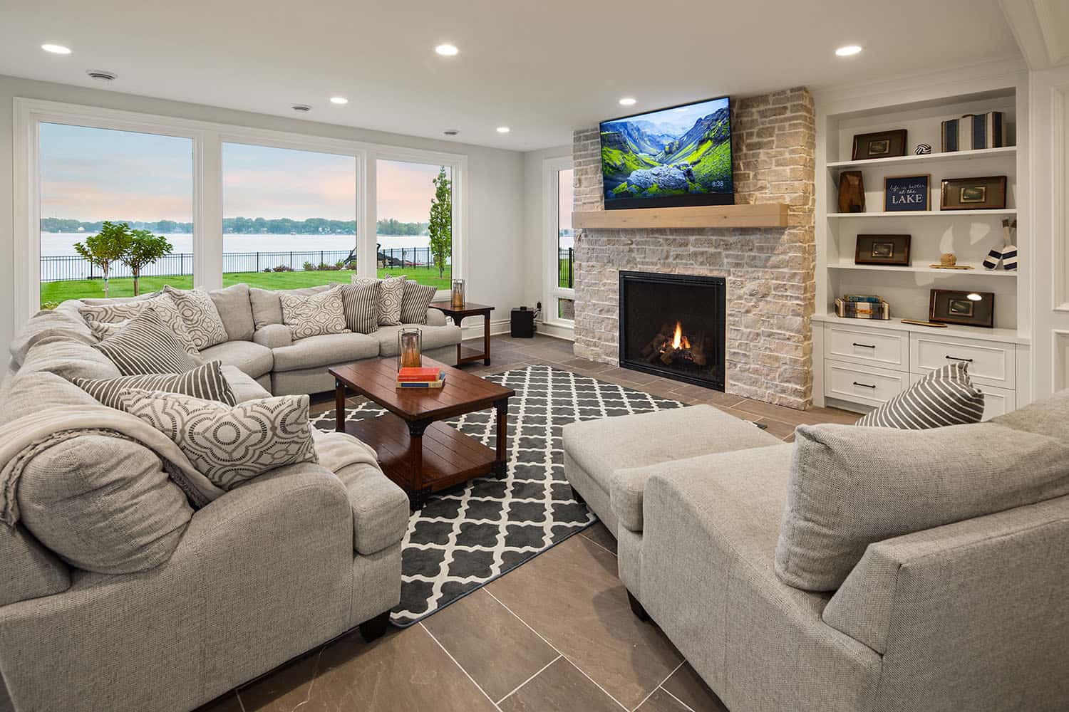 transitional style lower level family room with a fireplace