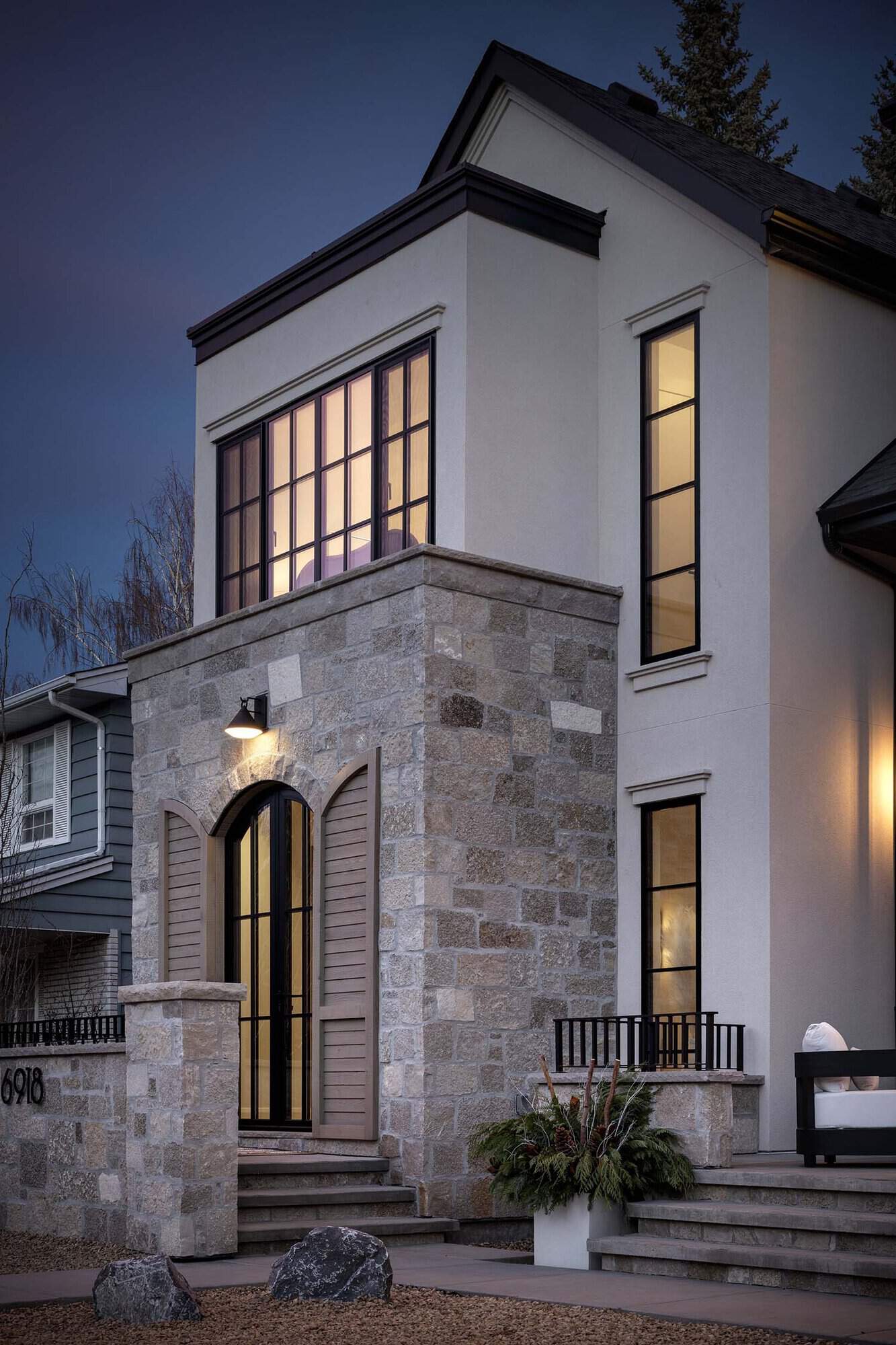 contemporary Tuscan inspired home exterior at dusk