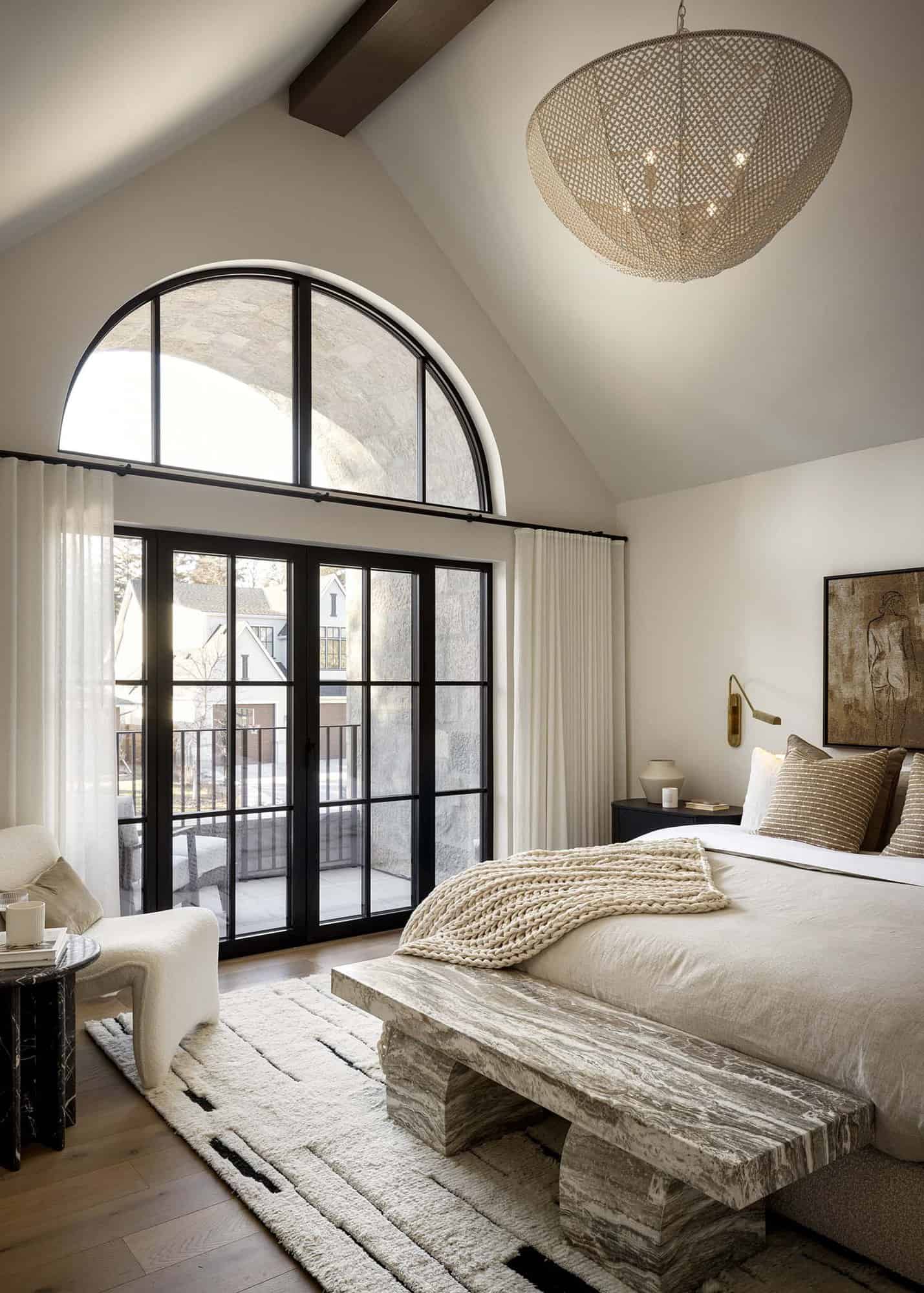 contemporary Tuscan-inspired bedroom with French doors leading out to a private balcony