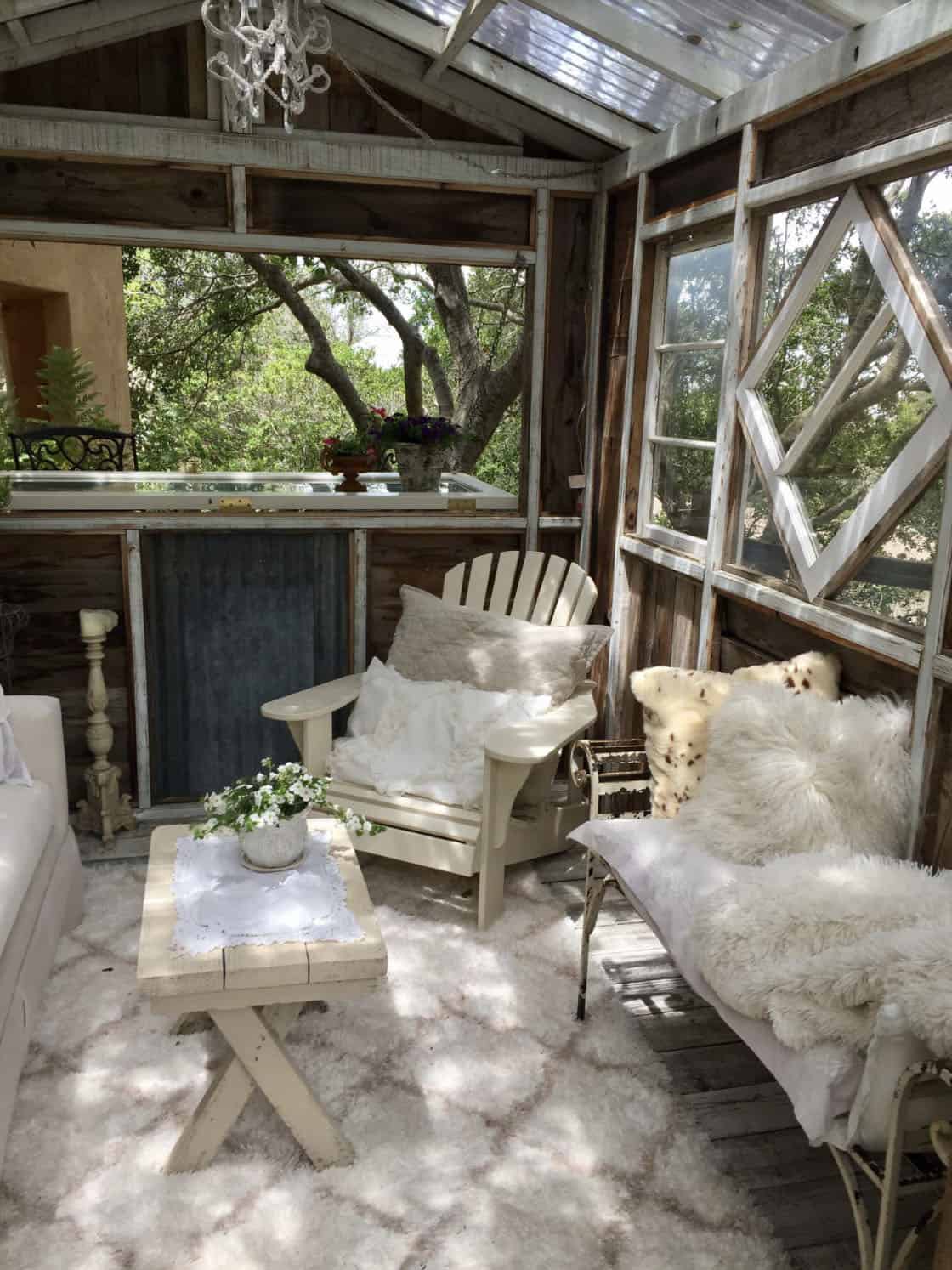 shabby-chic style shed with a sofa and Adirondack chair