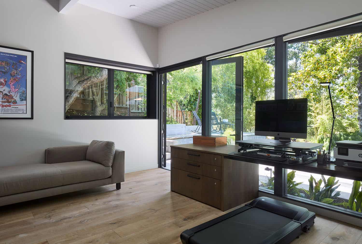 mid-century modern home office with an under deck treadmill