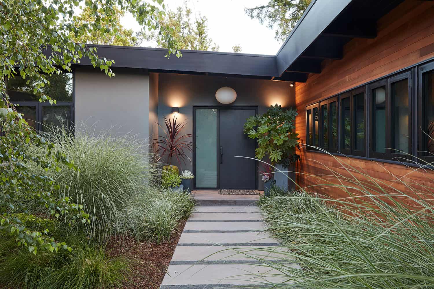 mid-century modern home exterior with a stepping stone walkway 