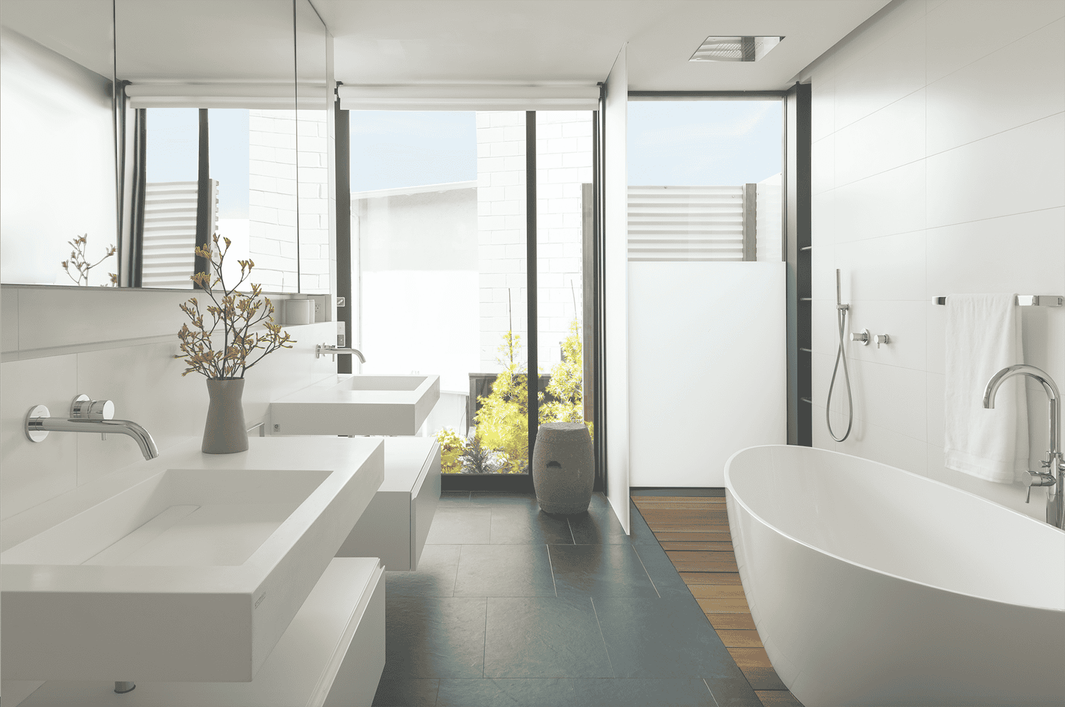 modern bathroom with dual vanities and freestanding tub