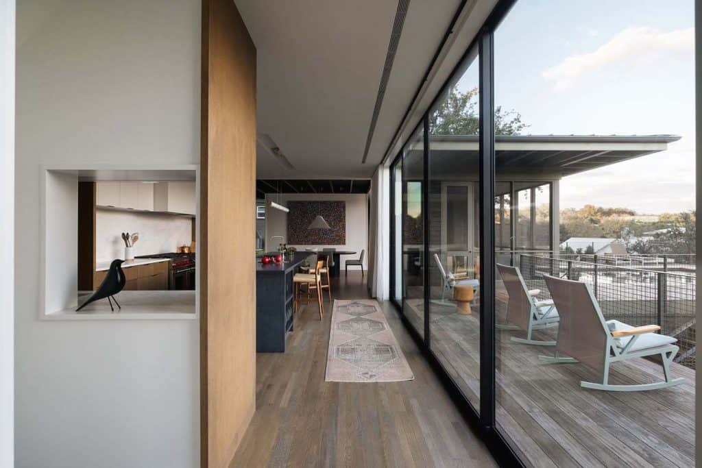 Majestic oak trees define a serene hillside home with Austin skyline views