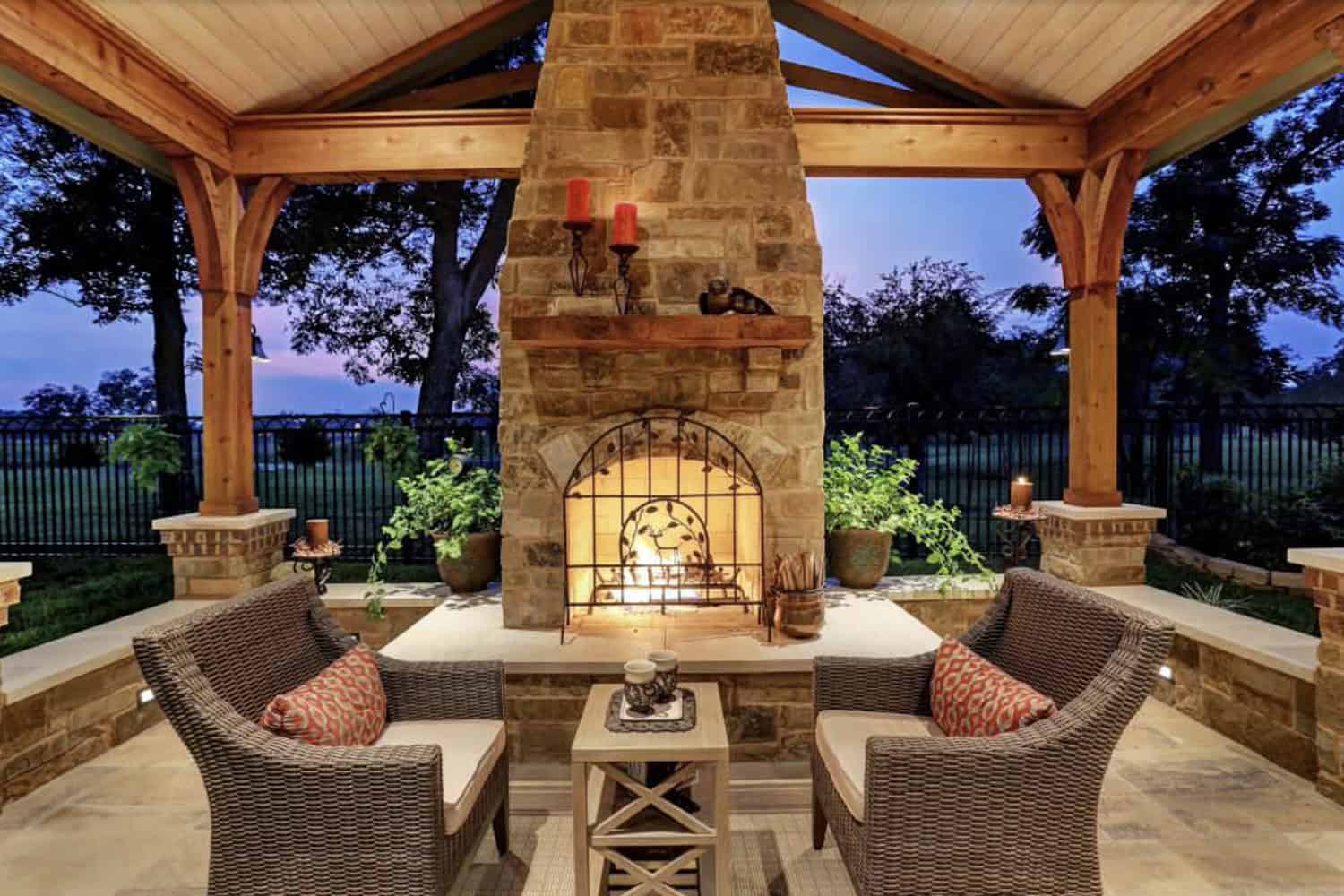 rustic covered patio with an outdoor fireplace