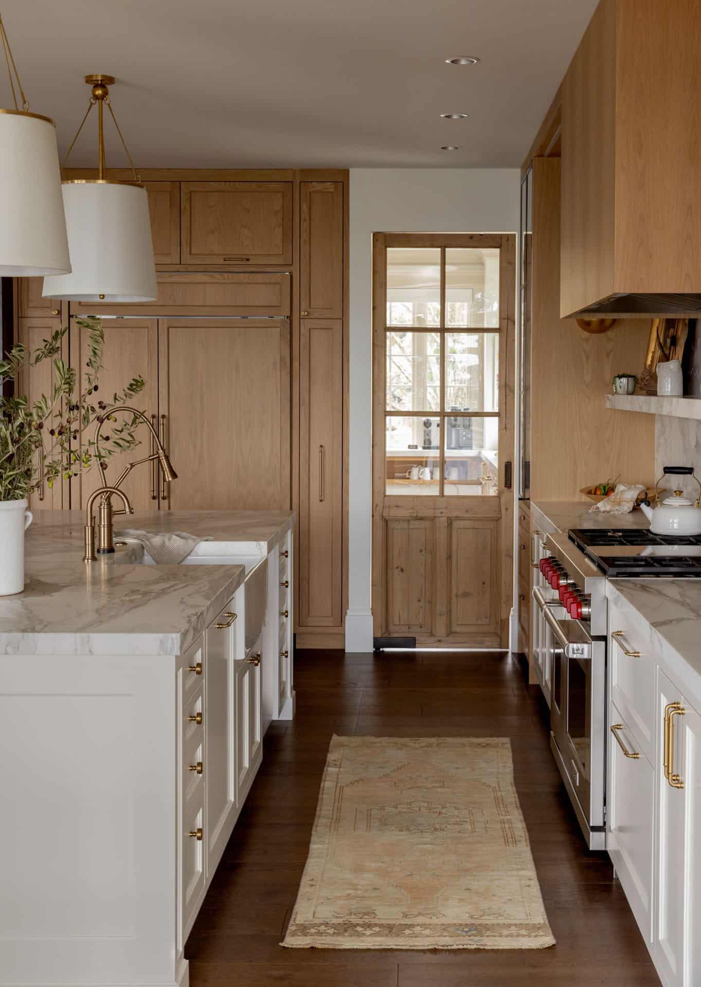 transitional style kitchen with a vintage door leading into the scullery