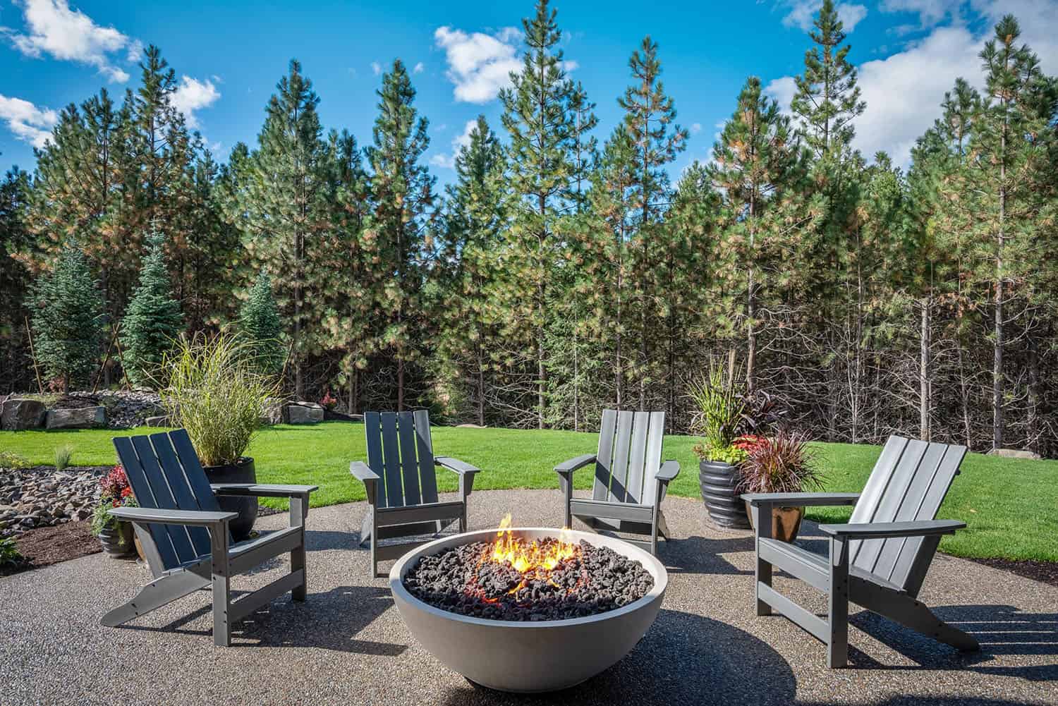 contemporary home backyard with a fire pit