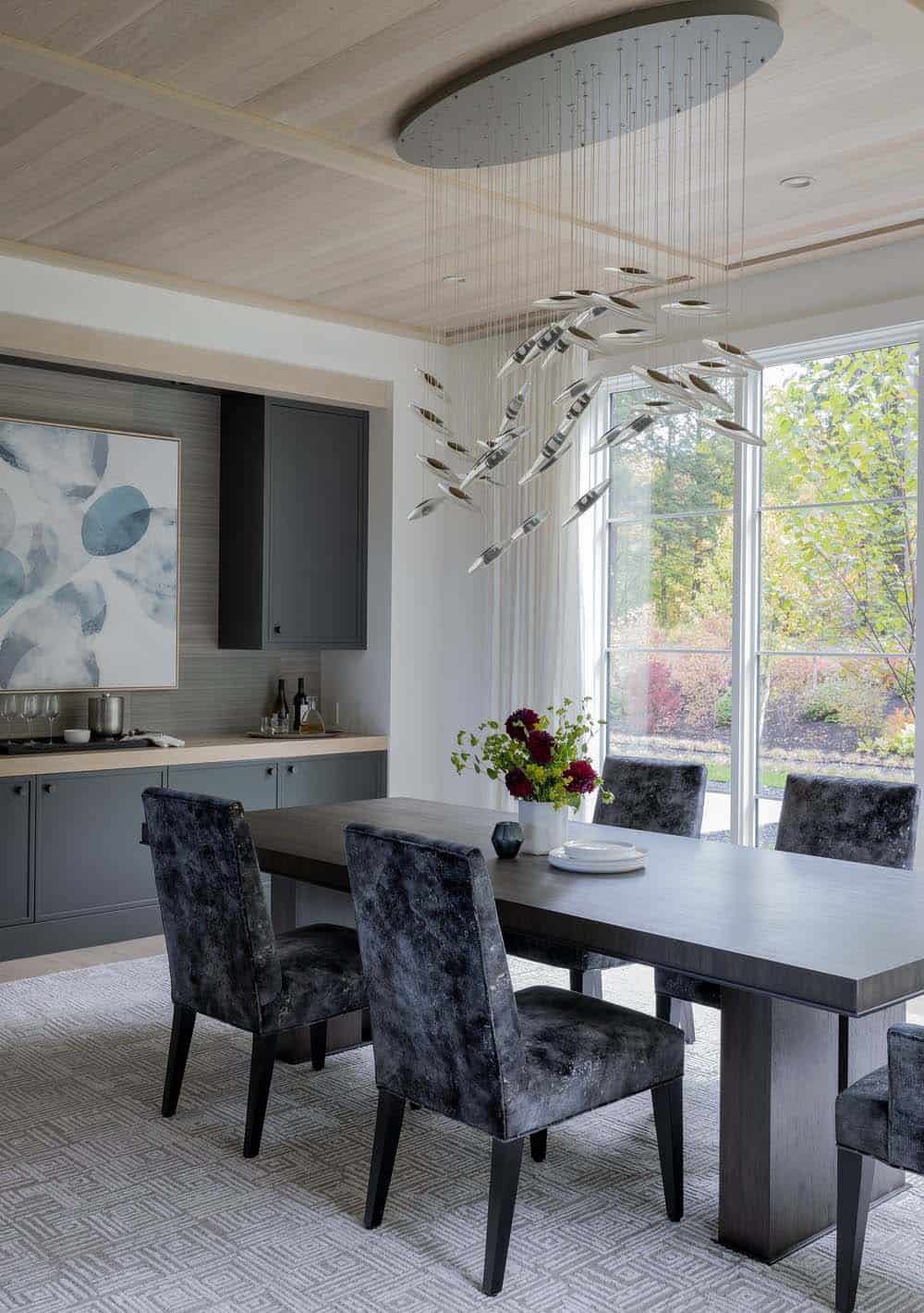 modern dining room with a large chandelier
