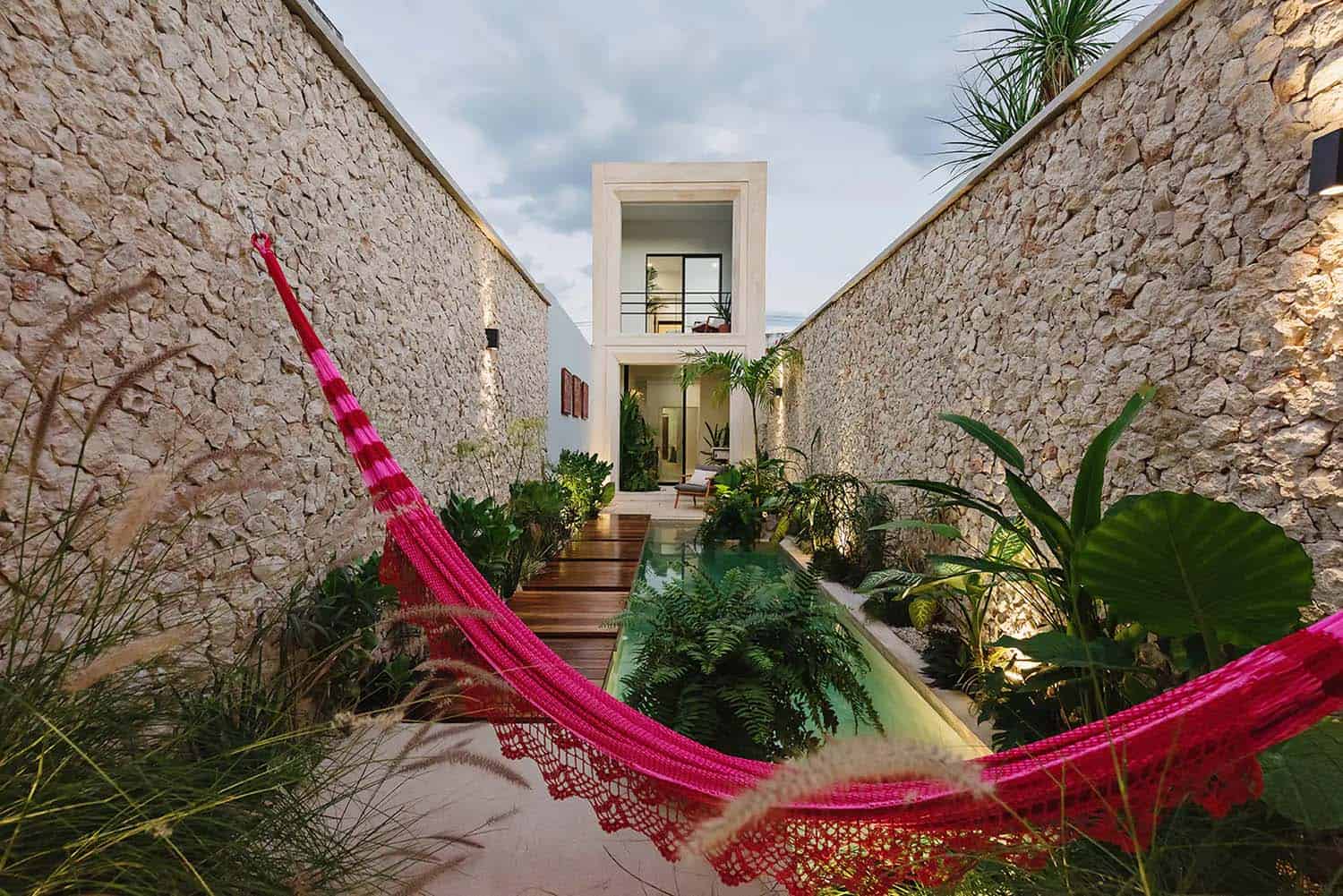 tropical small house exterior courtyard with a plunge pool and hammock