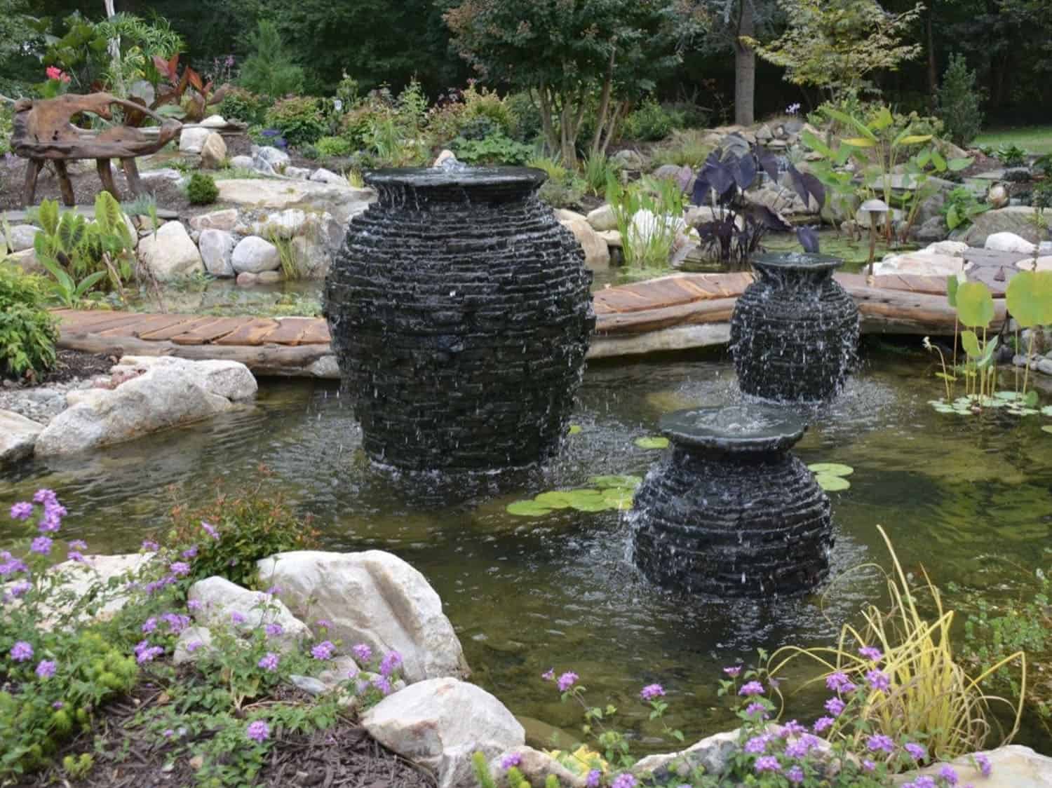 small pond with black urn water features