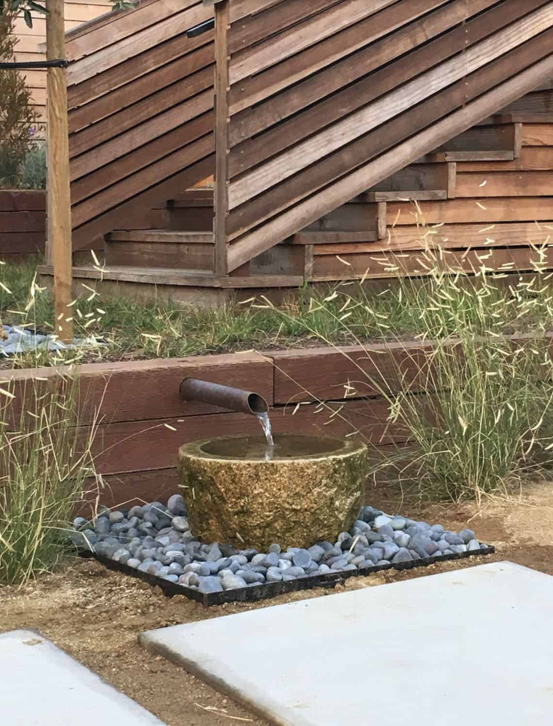 outdoor water feature with river rocks