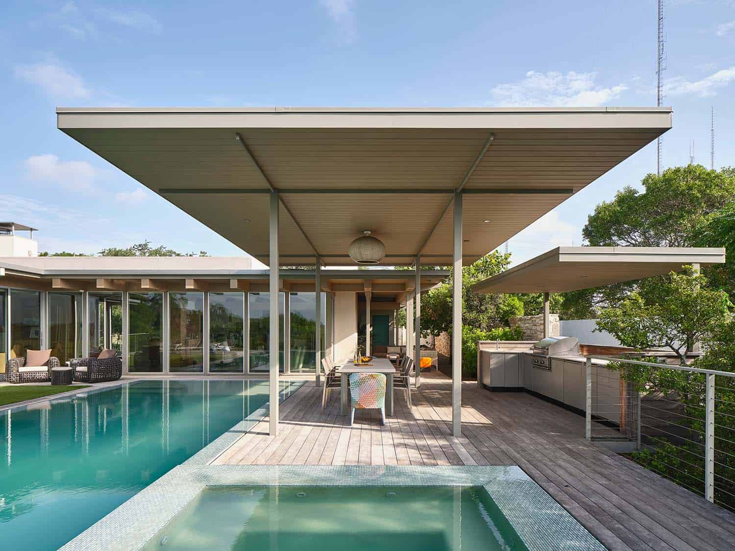midcentury modern house exterior with a pool and spa