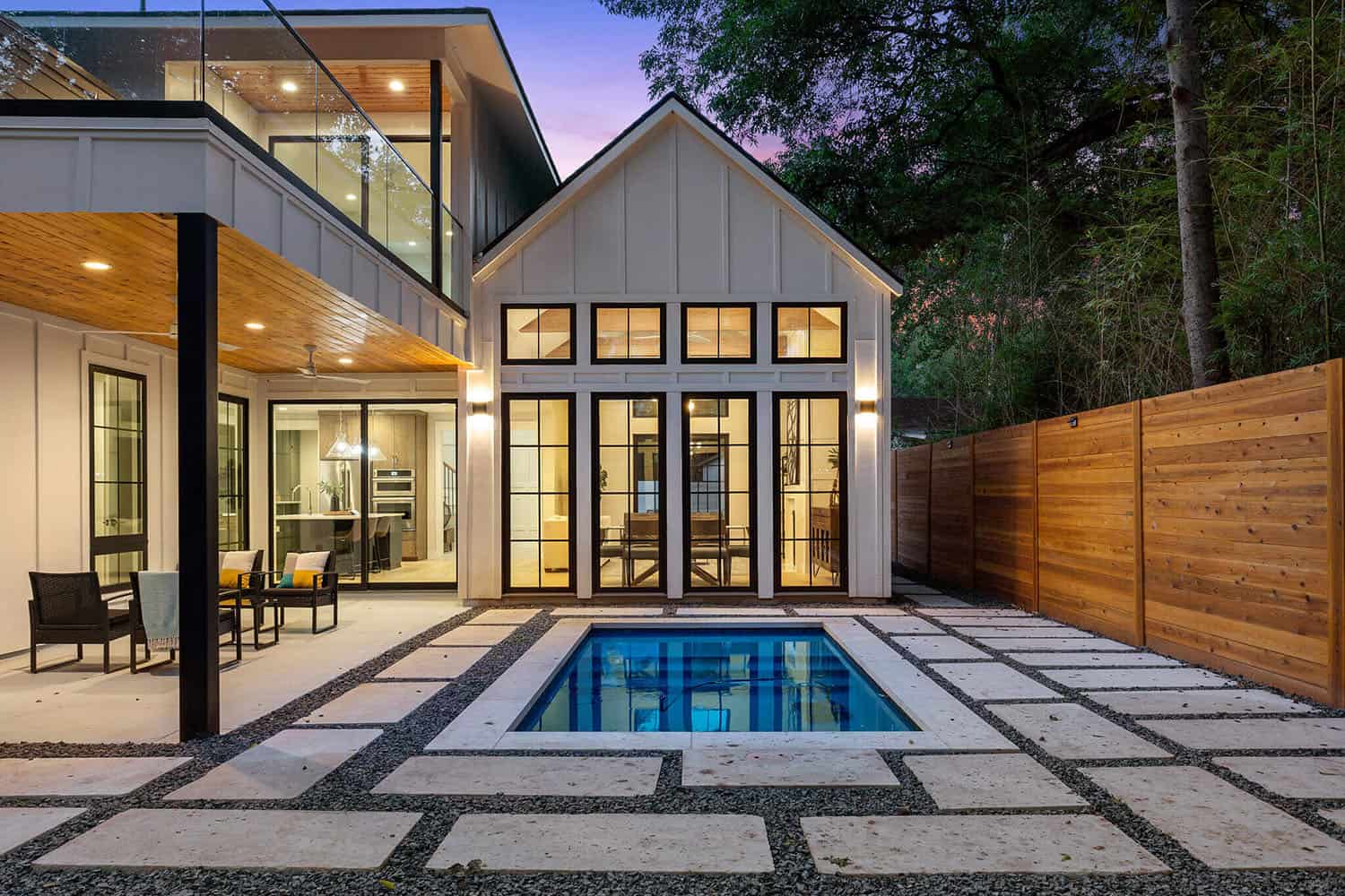 modern-farmhouse-backyard-with-a-pluge-pool-at-dusk