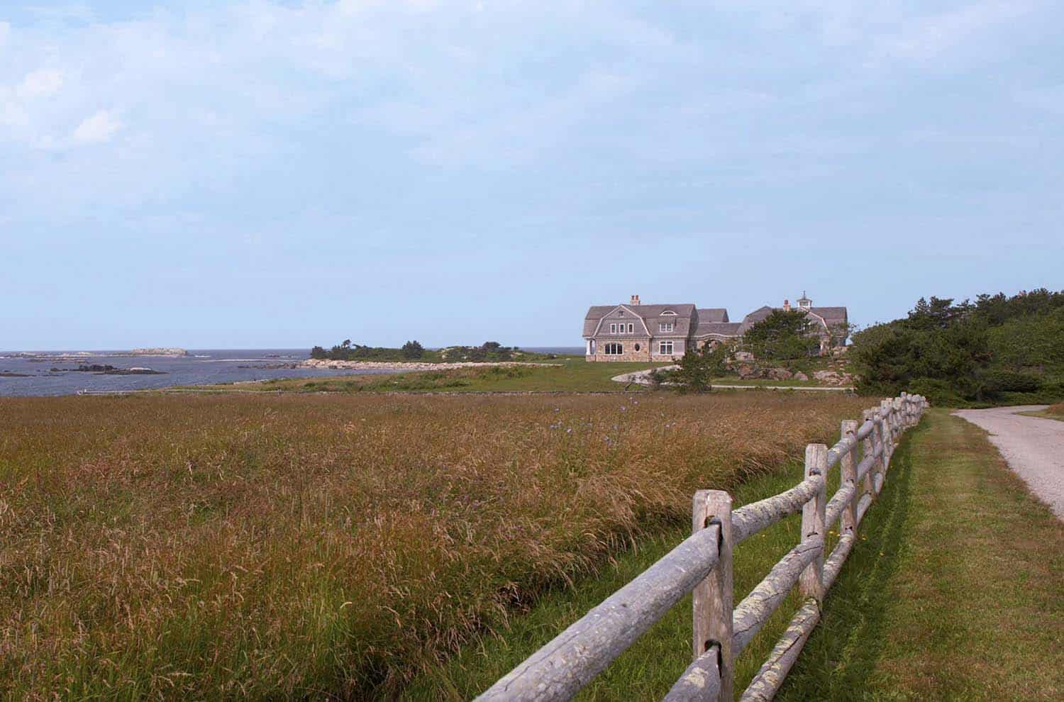 gambrel roof oceanfront home exterior with rolling farmland view