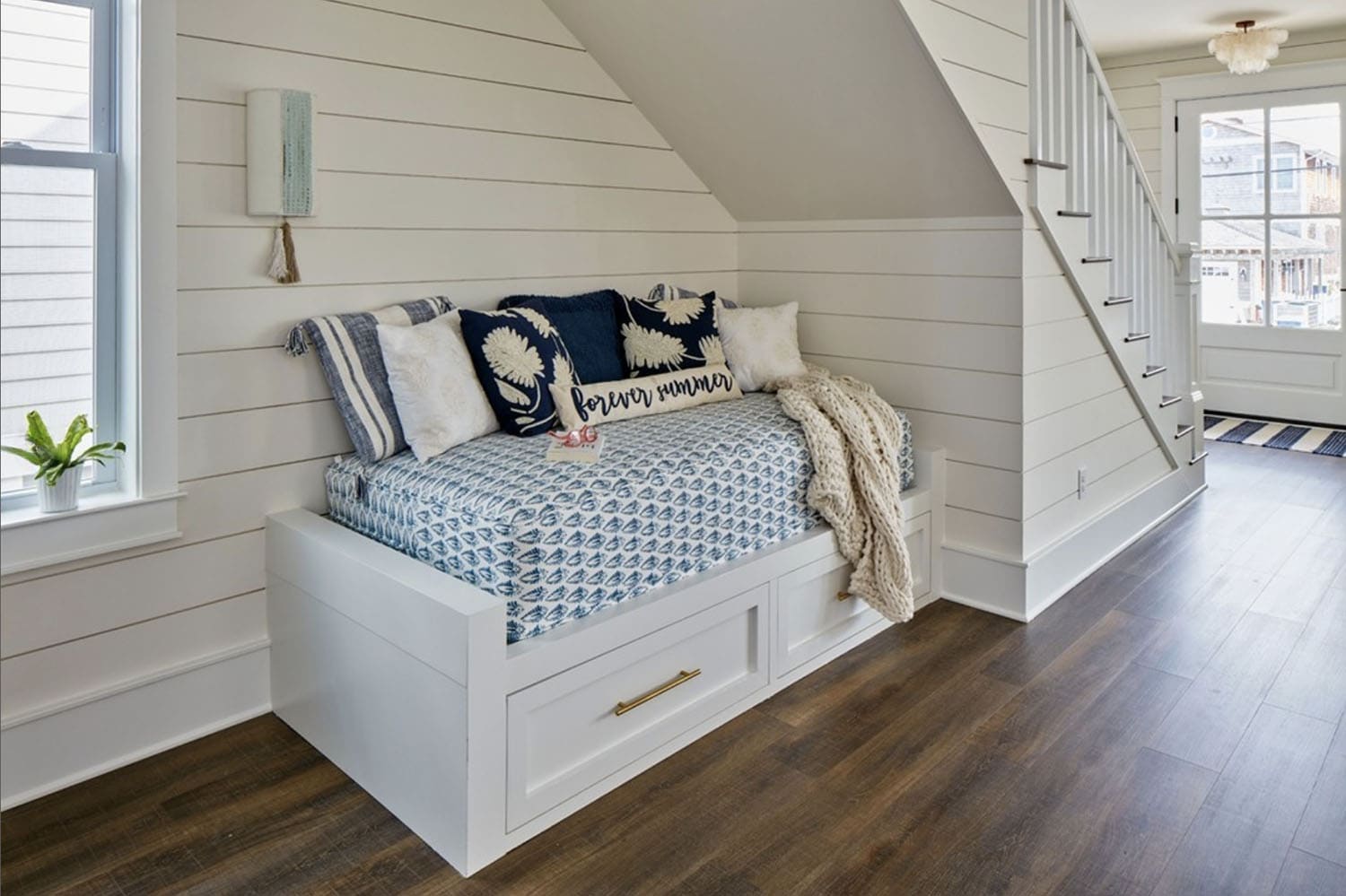 beach-style-under-stair-nook-with-a-daybed