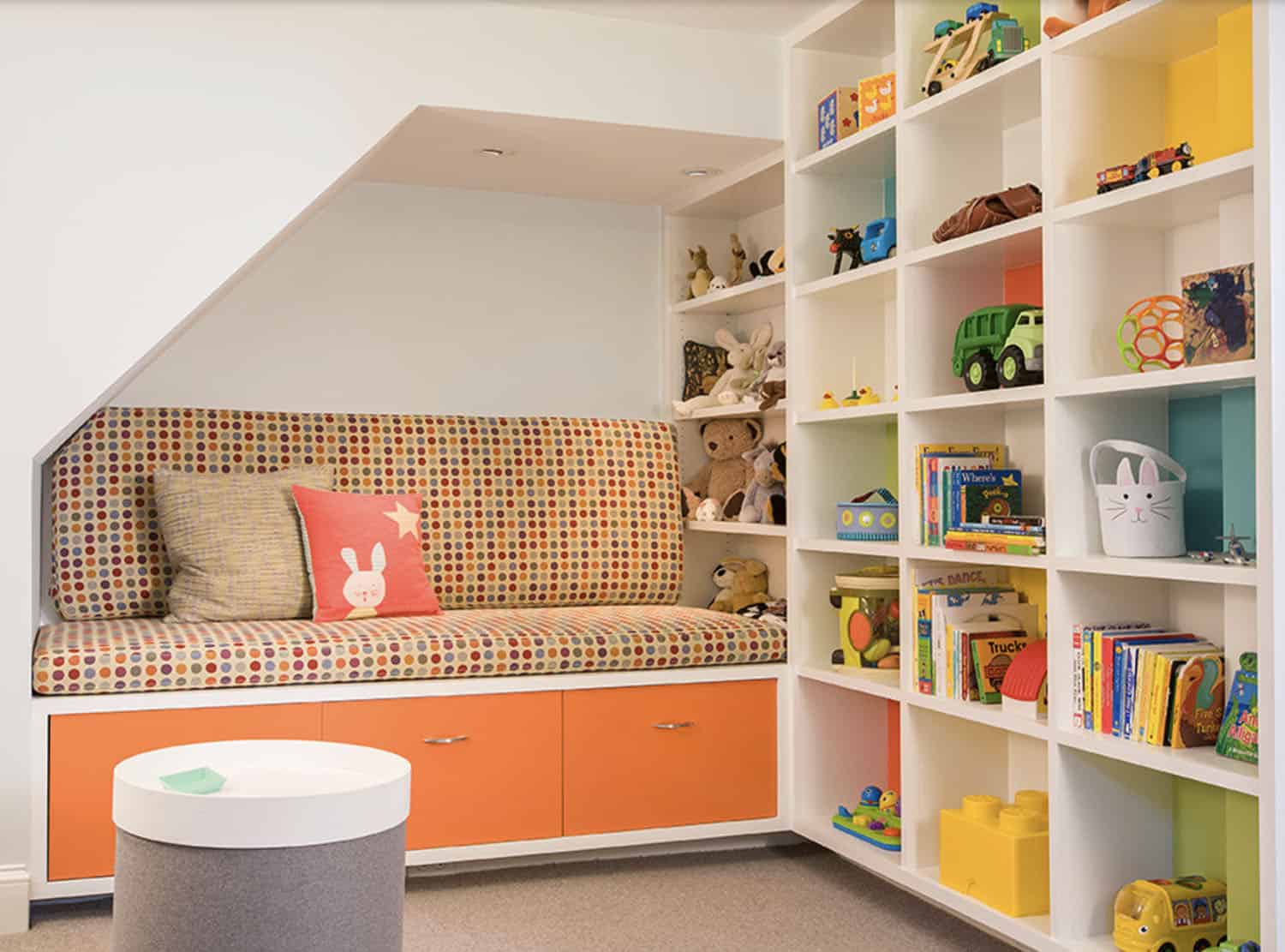 basement-playroom-built-in-seat-under-the-stairs