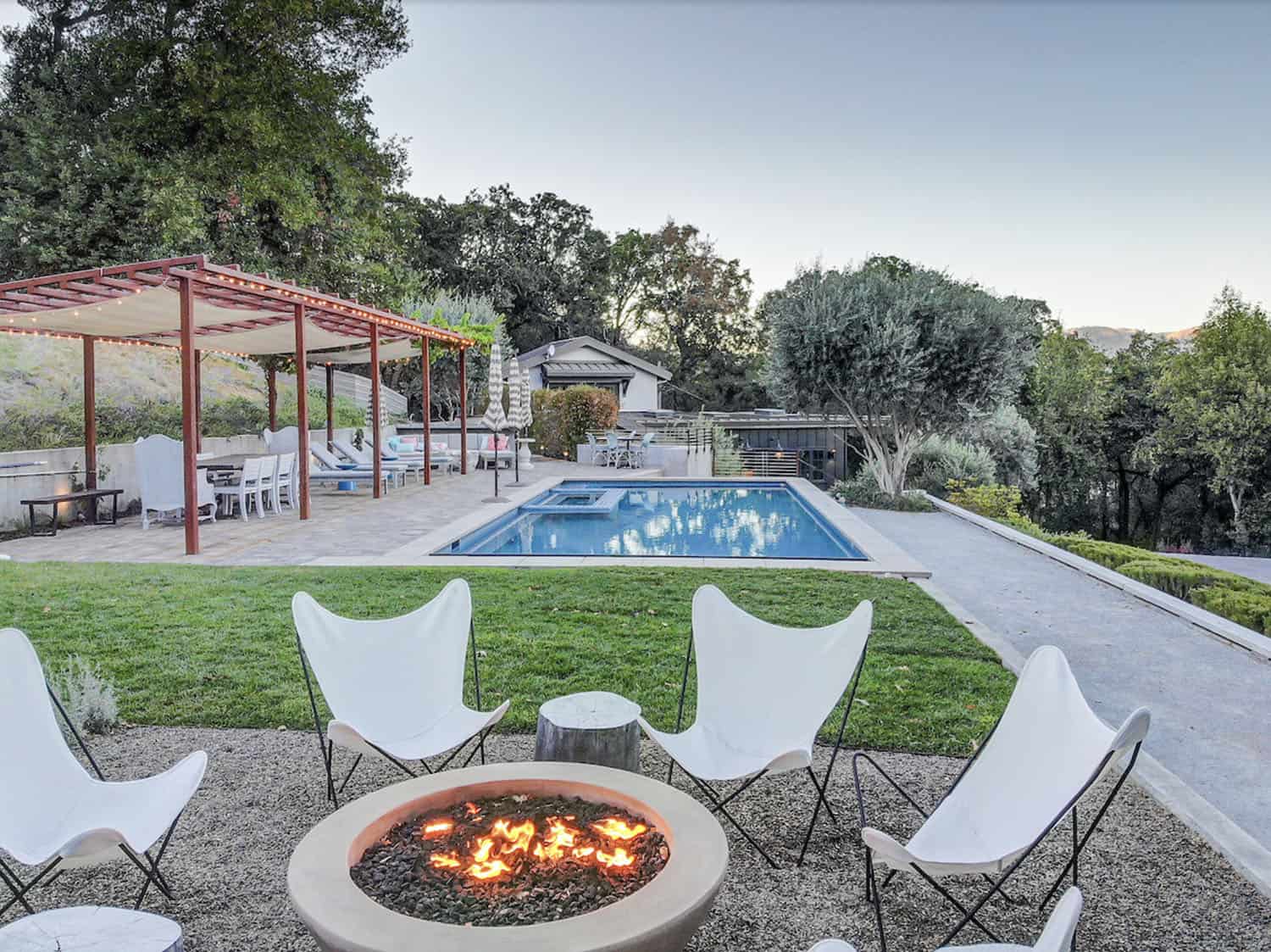 farmhouse-style-house-exterior-patio-with-a-fire-pit-and-pool