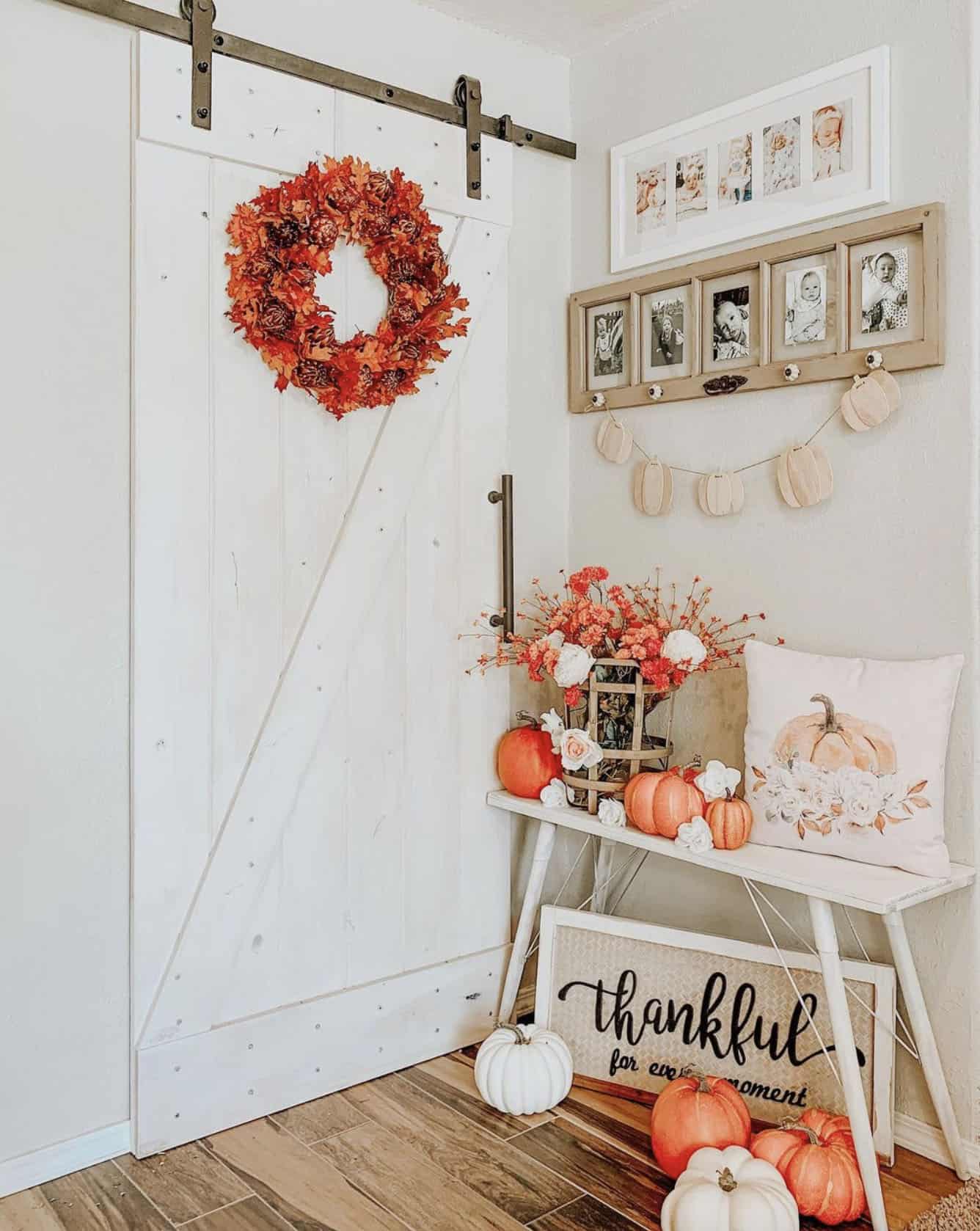 fall-decorated-entryway-with-orange-and-white-pumpkins-and-a-orange-wreath