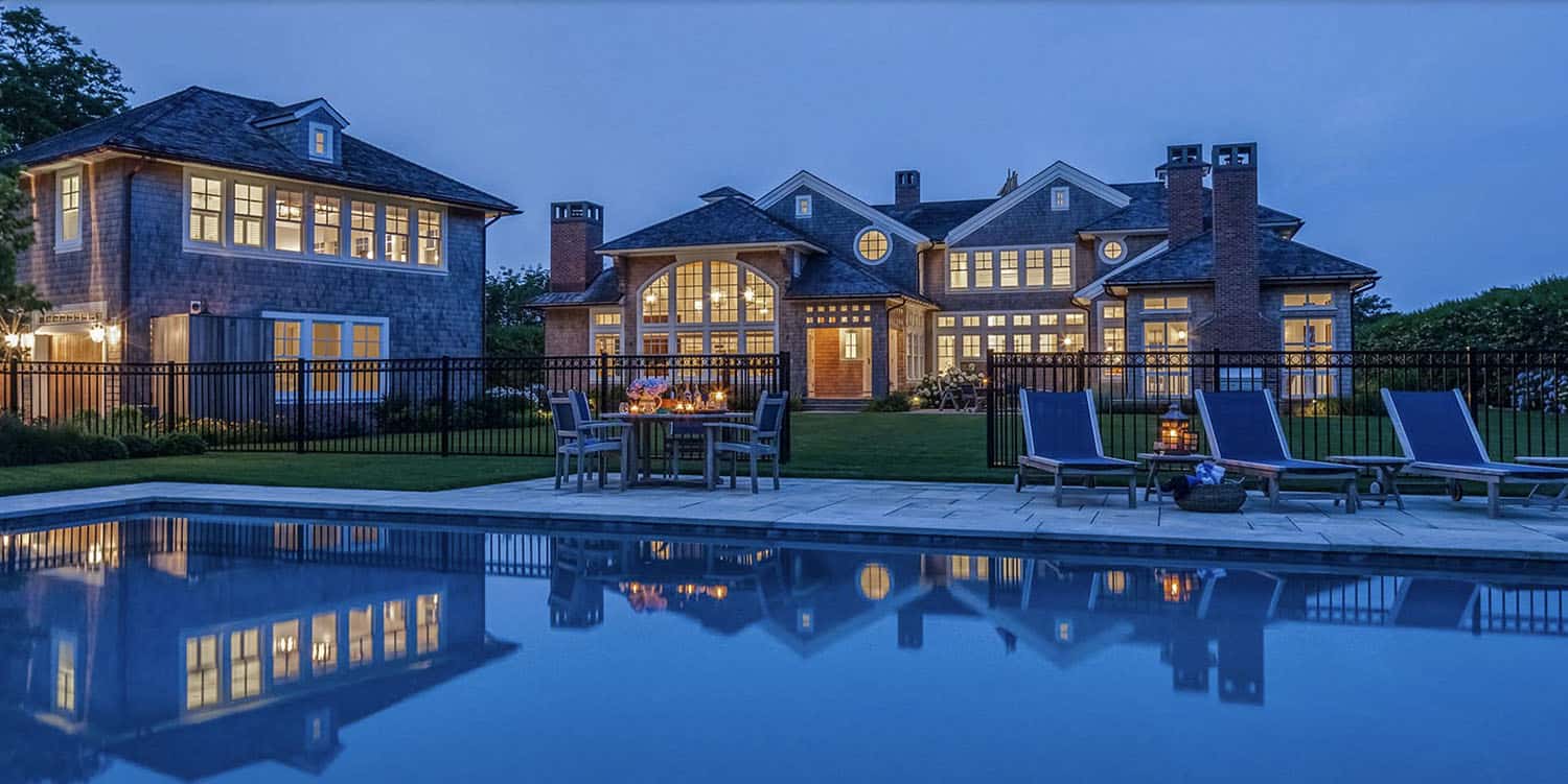 coastal-style-home-exterior-with-a-pool-at-dusk