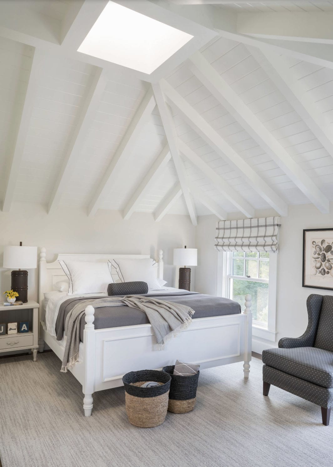 beach-style-bedroom-with-a-vaulted-ceiling-and-skylight