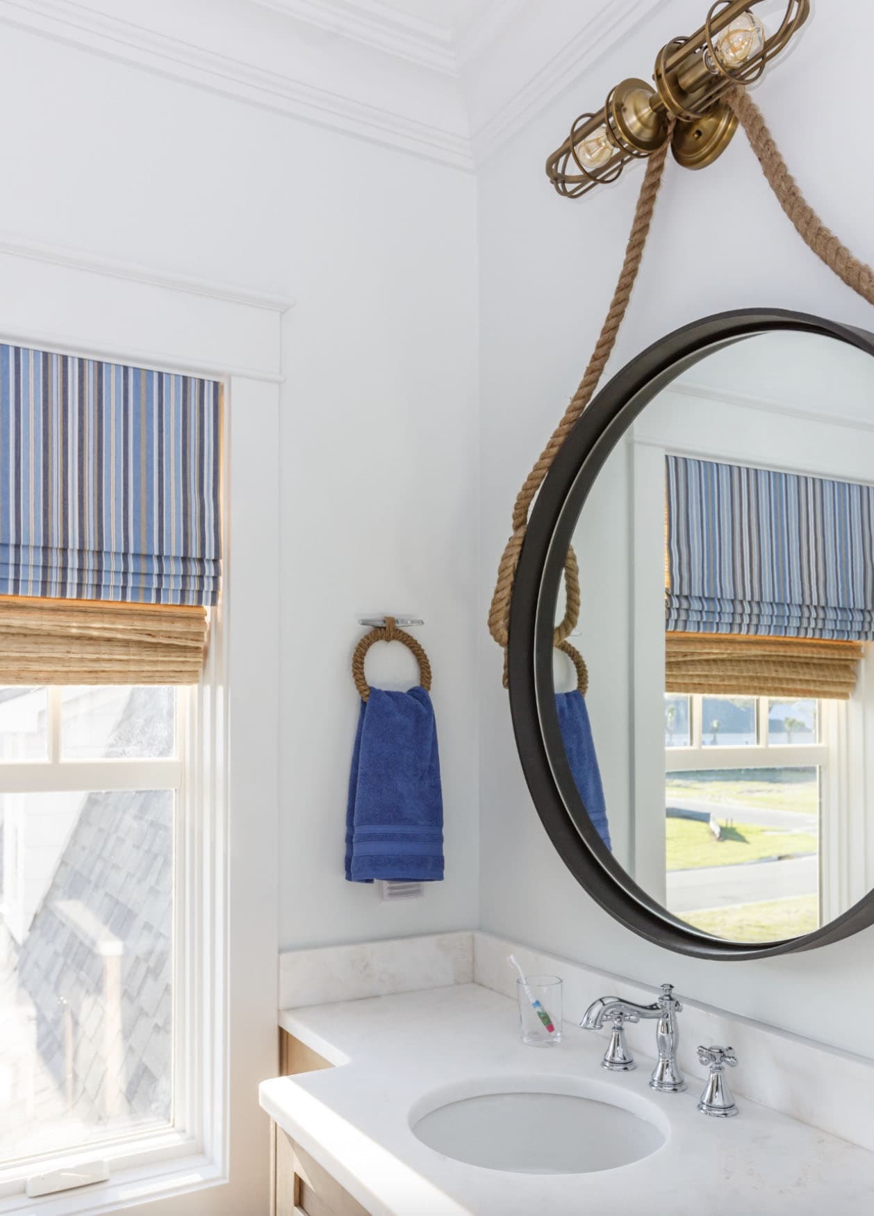 beach-style-bathroom-with-a-vanity-and-round-mirror