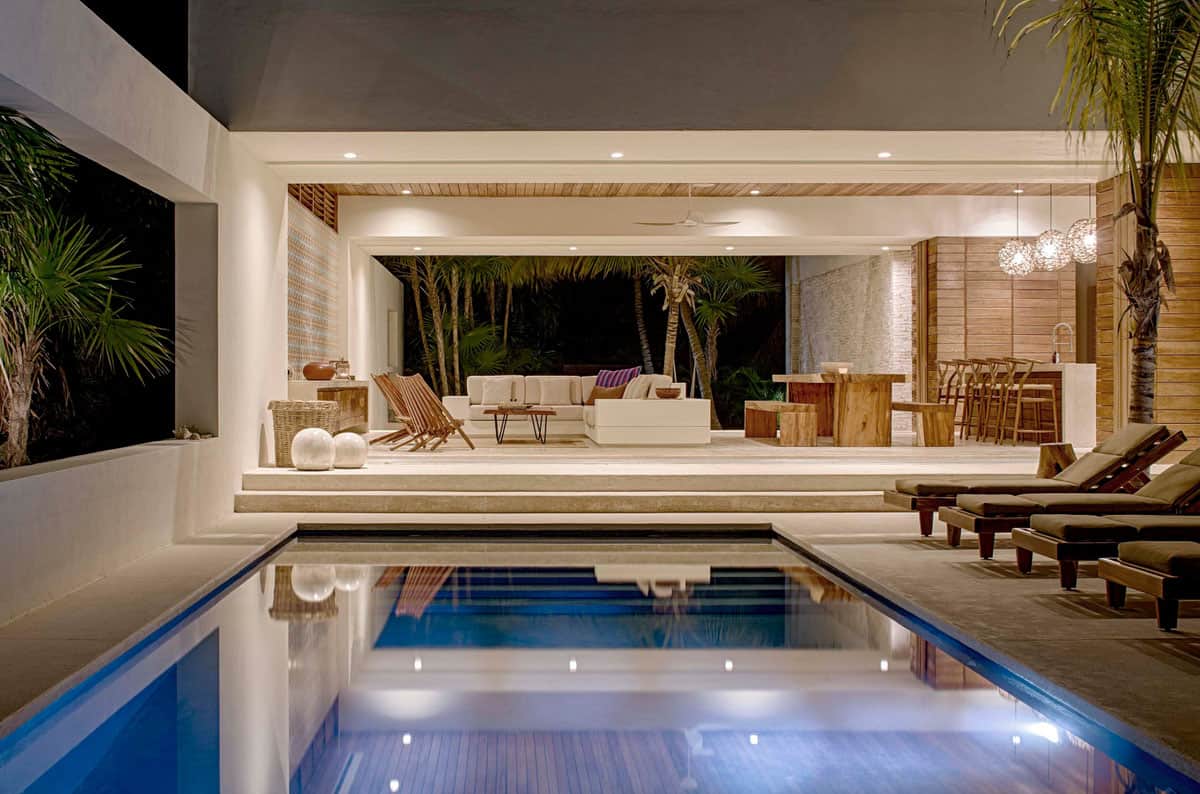 tropical-style-exterior-with-a-swimming-pool-at-dusk