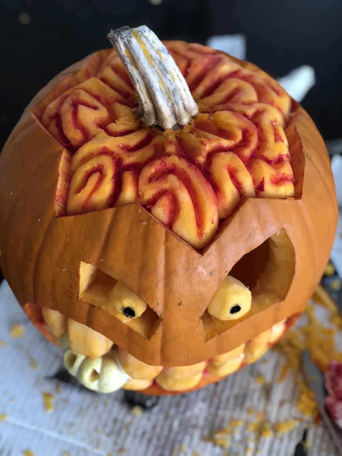 halloween pumpkin carving with its brains exposed