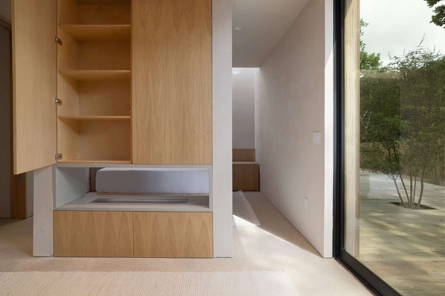 modern-bedroom-with-a-dual-sided-fireplace-with-a-integrated-cabinet