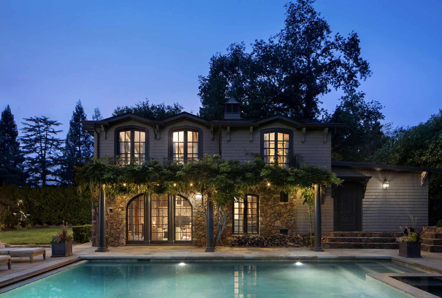 dutch-colonial-style-home-with-a-swimming-pool-at-dusk