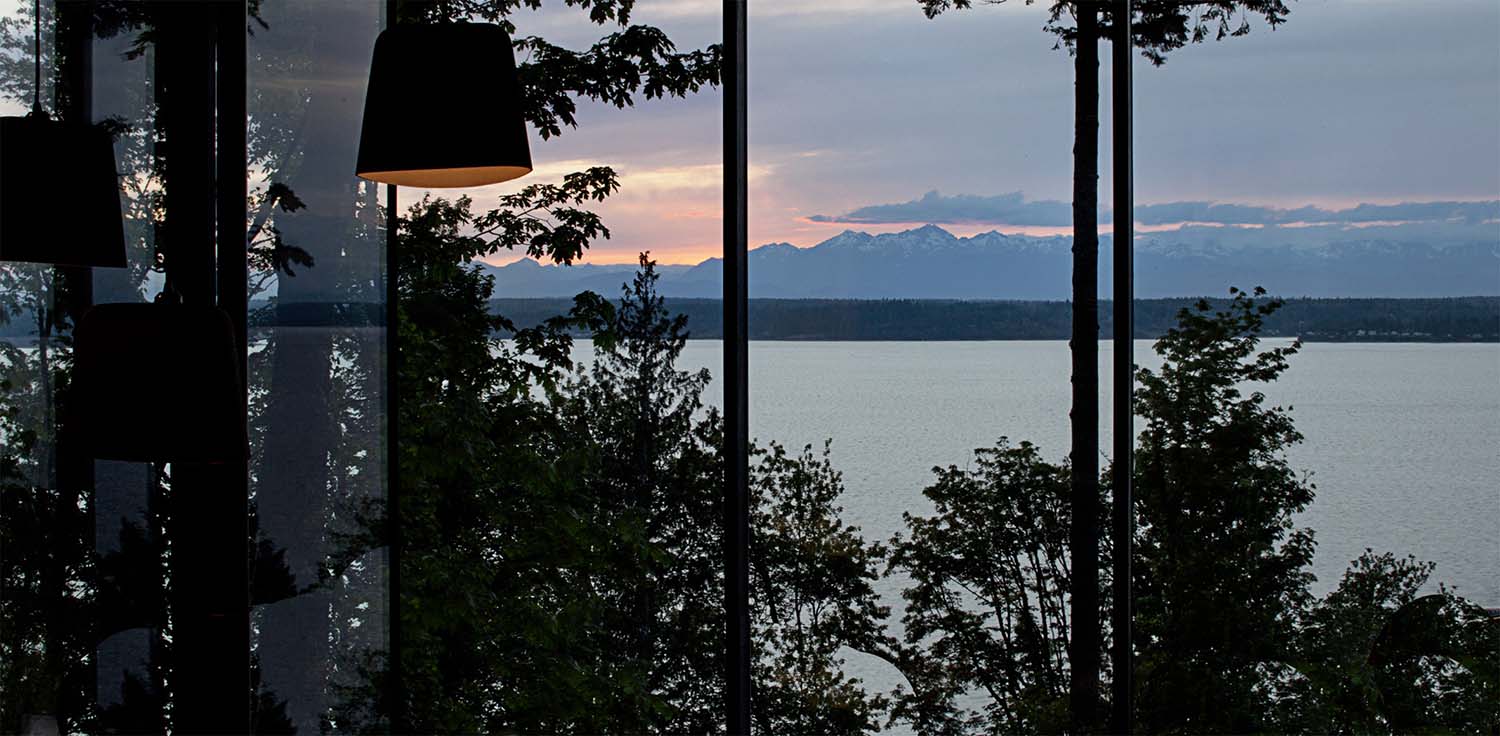 modern-living-room-with-a-large-window-at-dusk