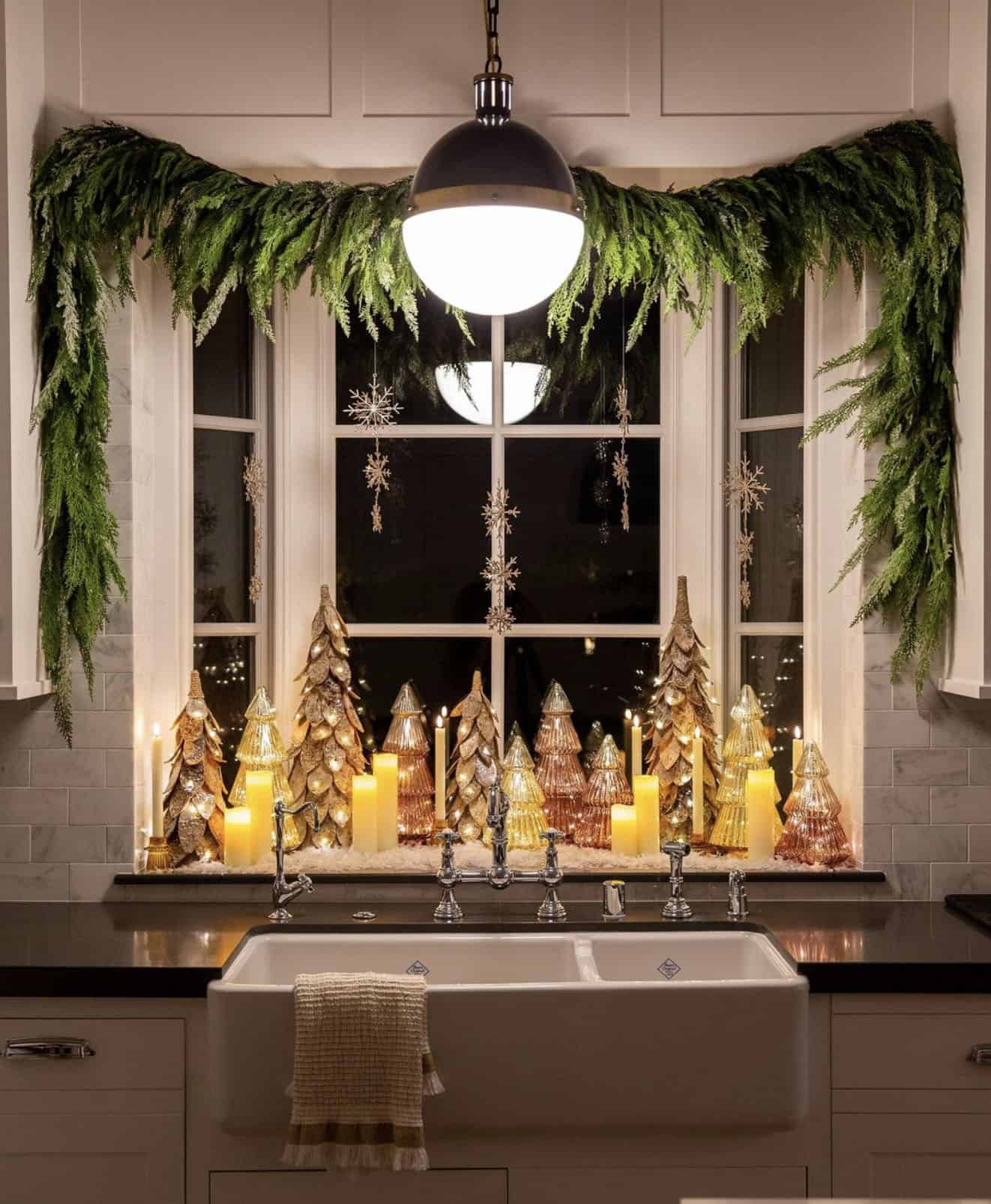 kitchen-window-vingnette-with-pine-garland-mini-christmas-trees-and-candles