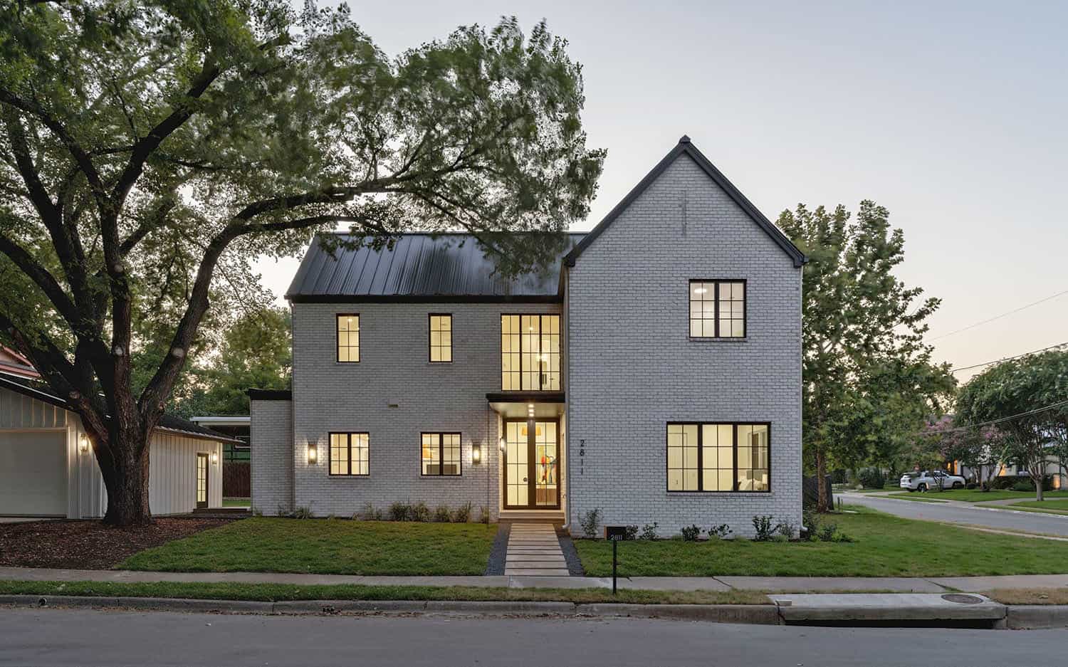 contemporary-white-brick-home-exterior-at-dusk