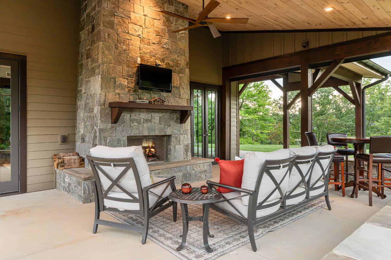 contemporary-craftsman-style-covered-porch-with-outdoor-furniture-and-a-fireplace