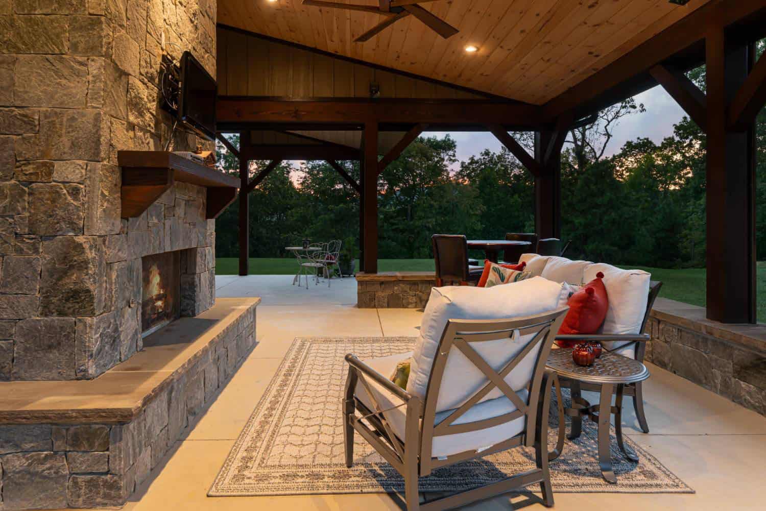 contemporary-craftsman-style-covered-porch-with-outdoor-furniture-and-a-fireplace