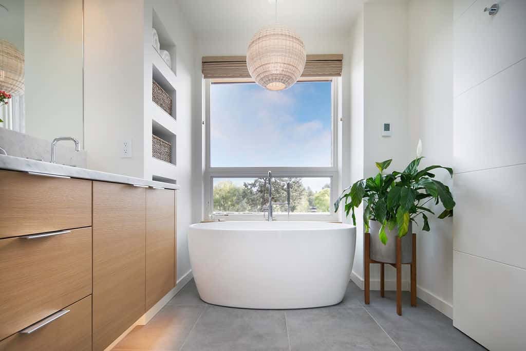 modern-bathroom-with-a-freestanding-tub-and-large-window