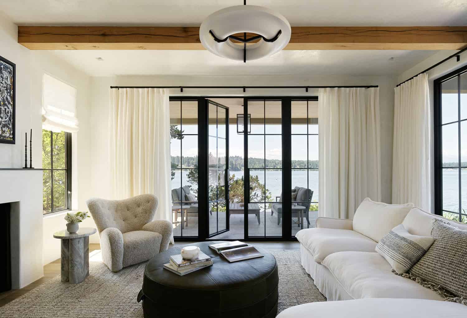 contemporary-family-room-with-french-doors-leading-out-to-a-patio-overlooking-the-water